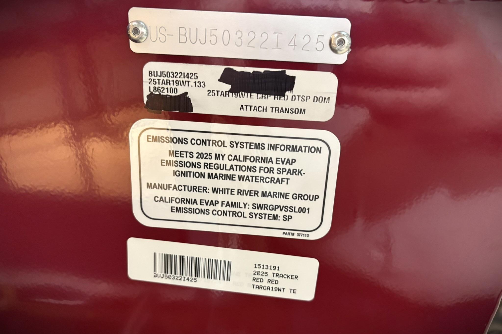 2025 Tracker Targa V-19 WT emissions control label on red surface.