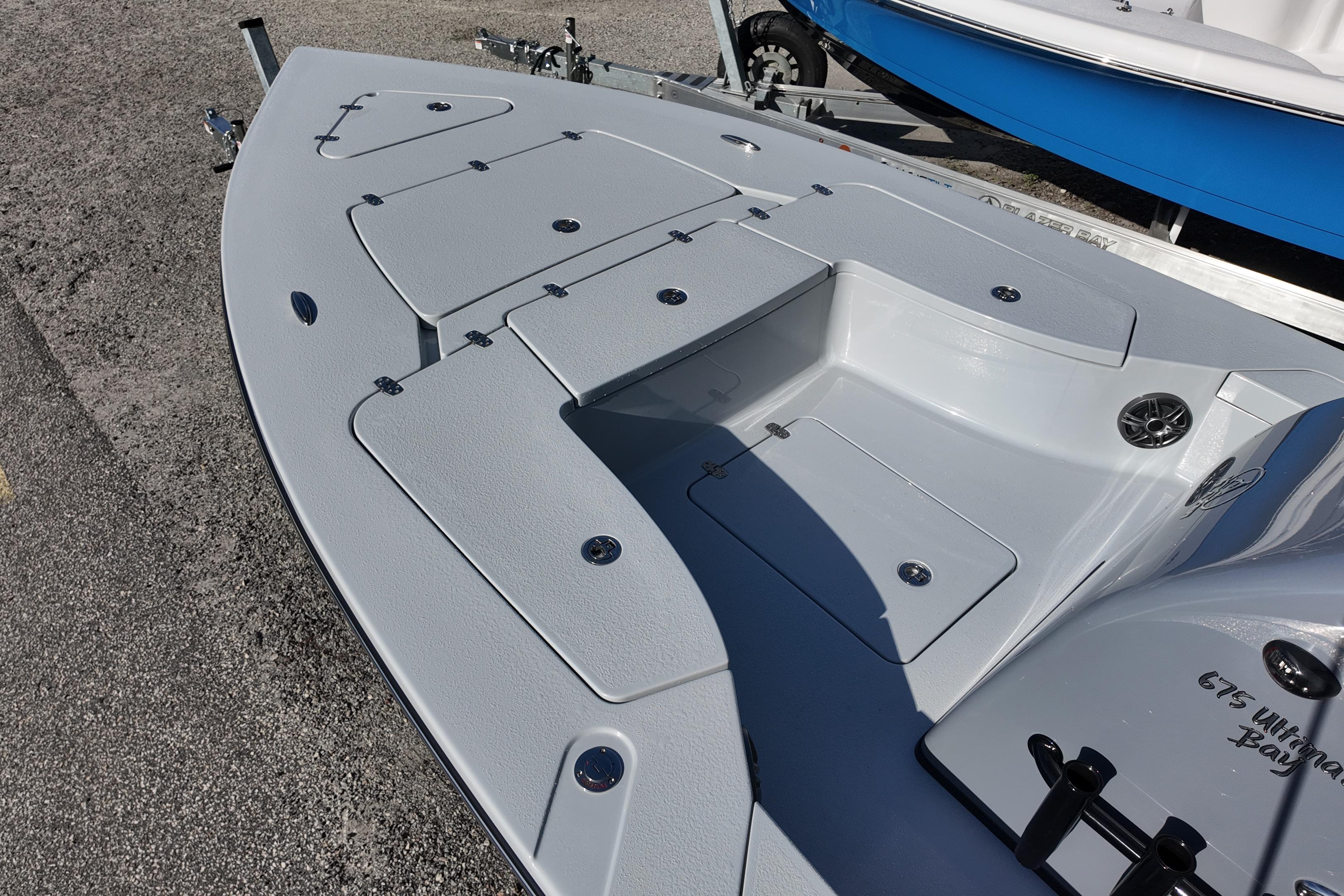 2026 Blazer Bay 675 Ultimate Bay boat deck with storage compartments and sleek design.