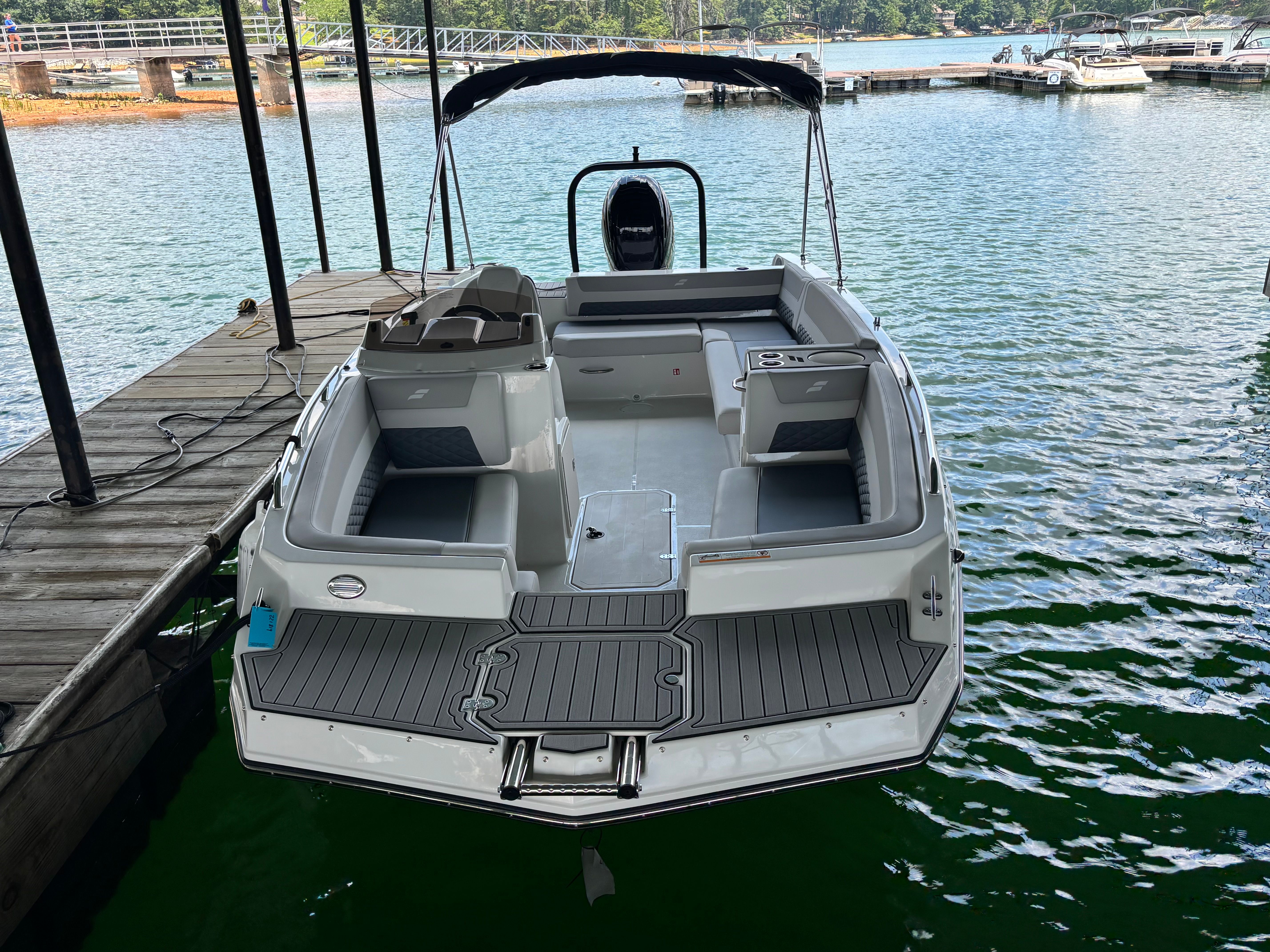 The image shows a 2027 Starcraft 211SVXOB boat docked on the water.