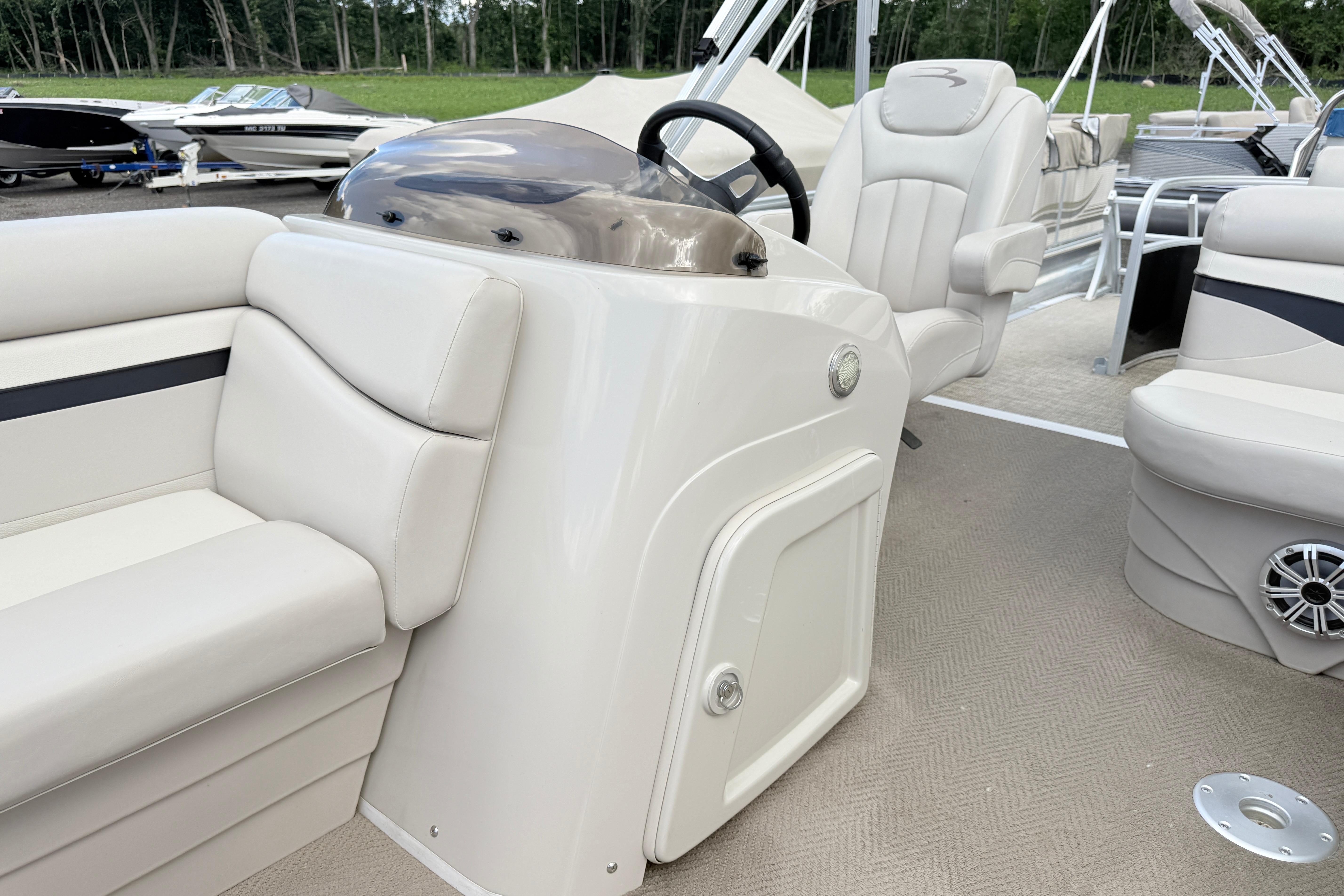 2015 Bennington 24SSLX pontoon boat interior with plush seating and steering console.