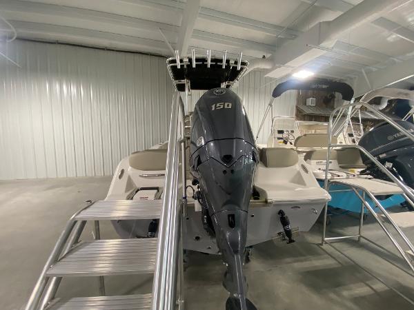 2024 Key West 203 FS boat with 150 HP engine in showroom.