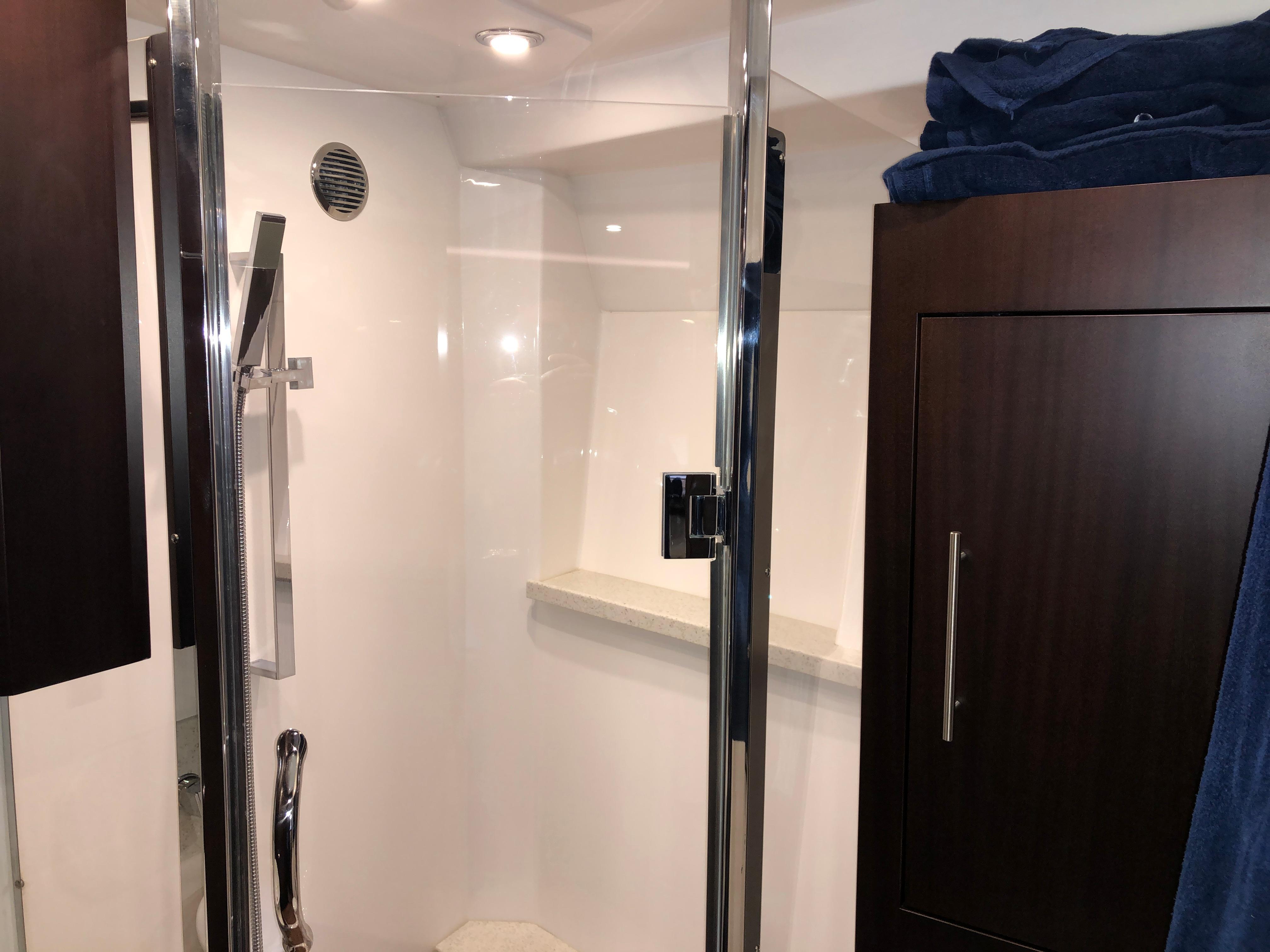 Luxurious bathroom in 2017 Regal 53 Sport Coupe yacht with modern shower and sleek cabinetry.