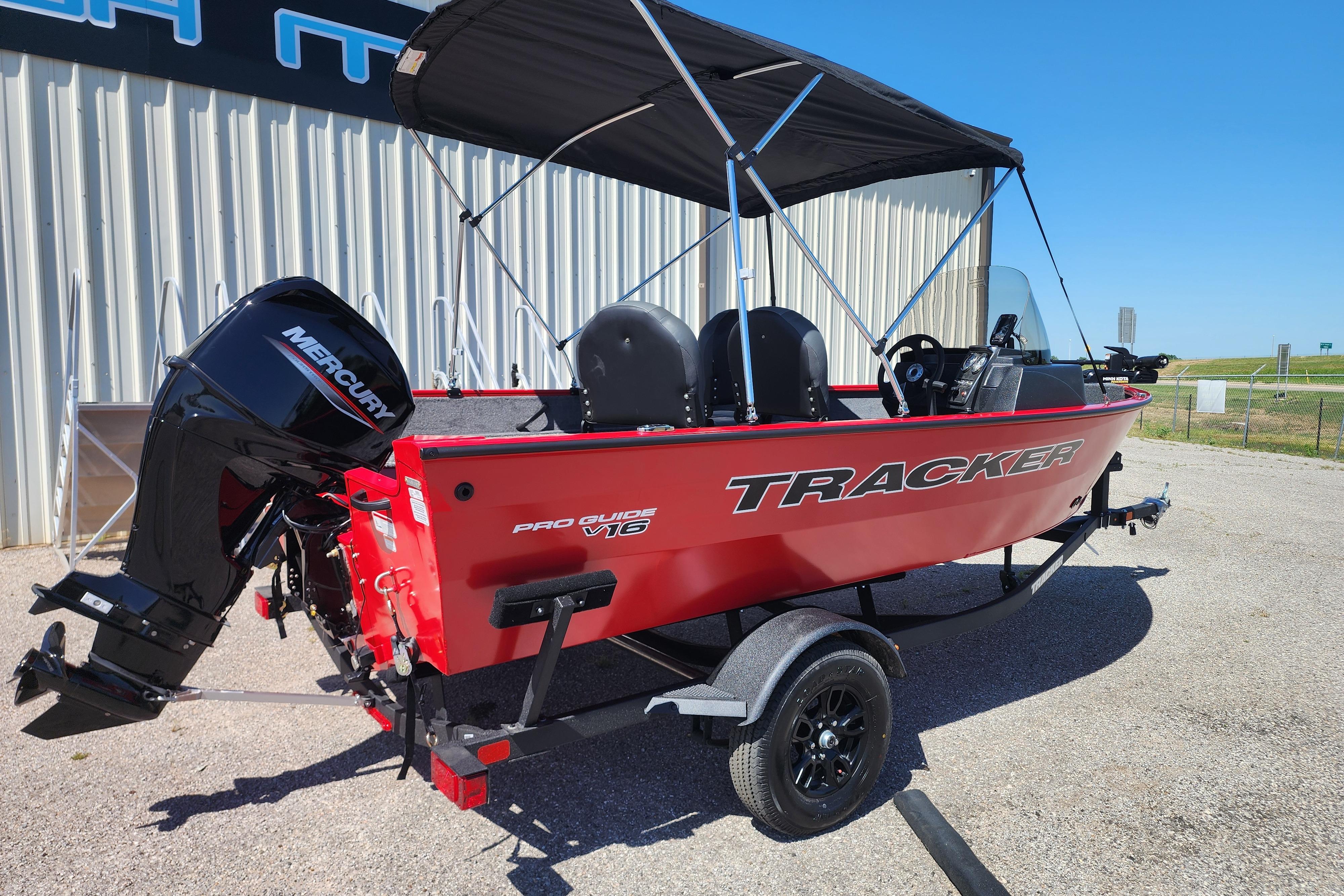 2026 Tracker Pro Guide V-16 SC boat with Mercury engine, parked outdoors.