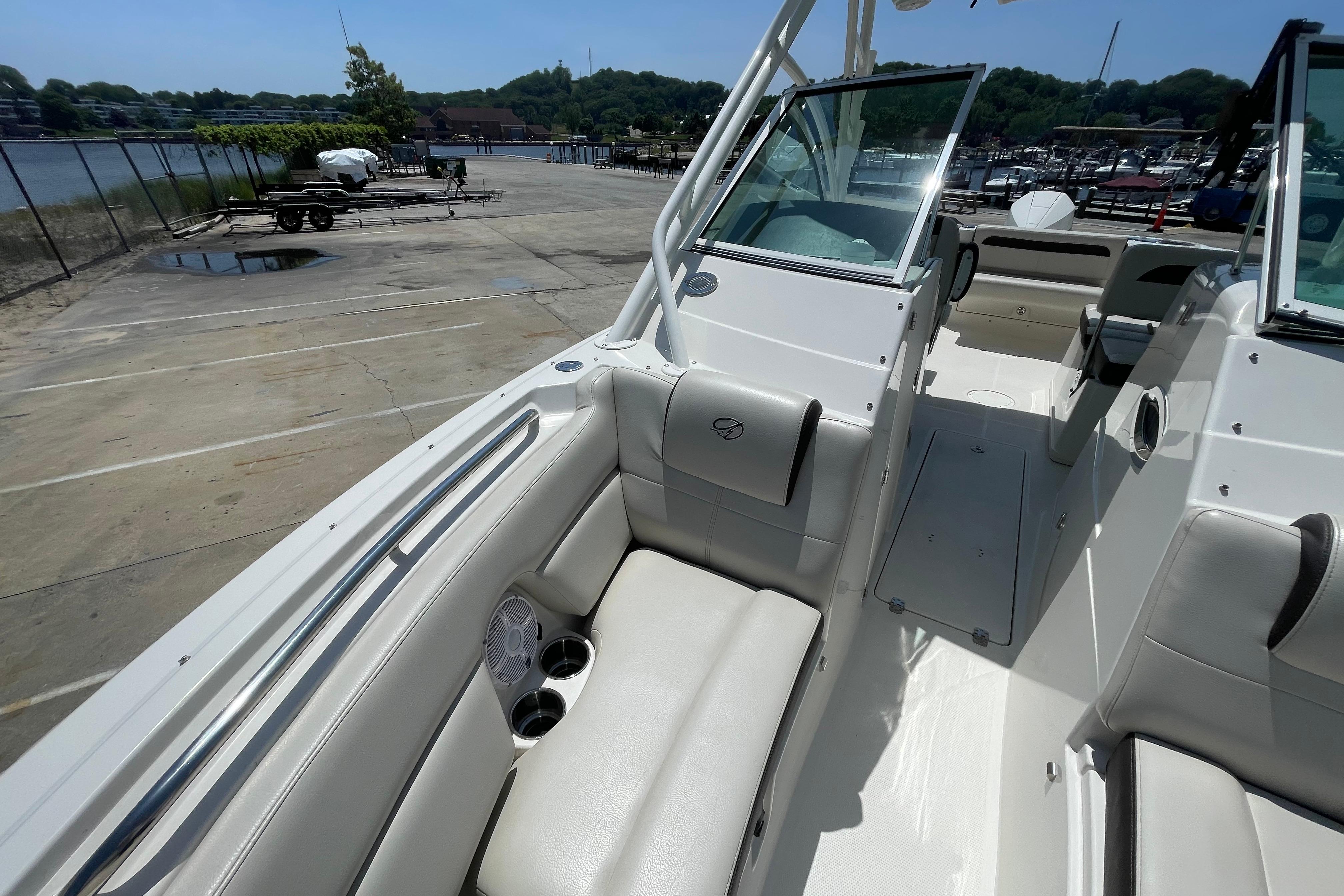 2022 Sailfish 245 DC boat interior with seating, cup holders, and waterfront view.