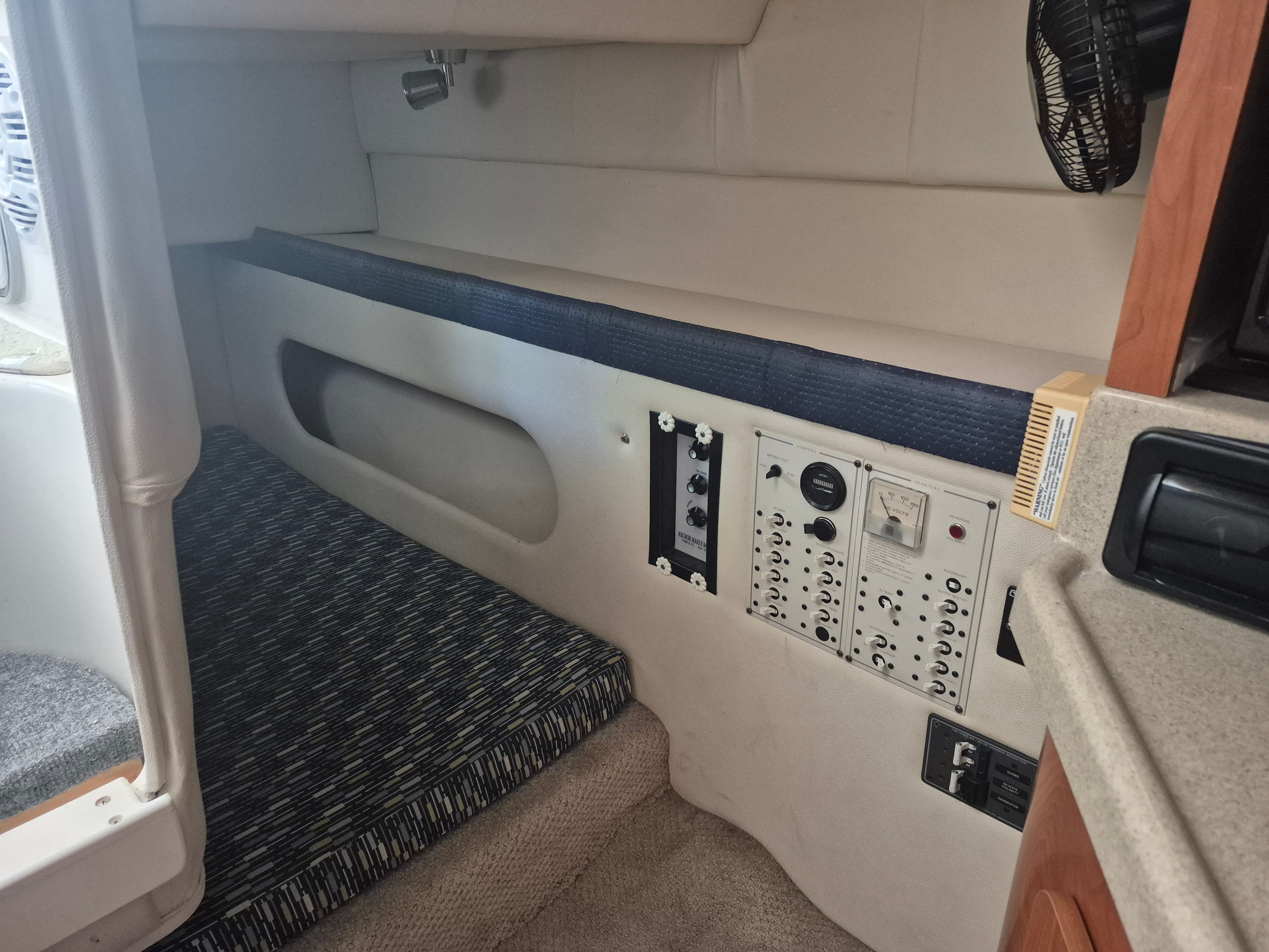 Interior of a 2004 Larson Cabrio 274 with control panel and seating area.