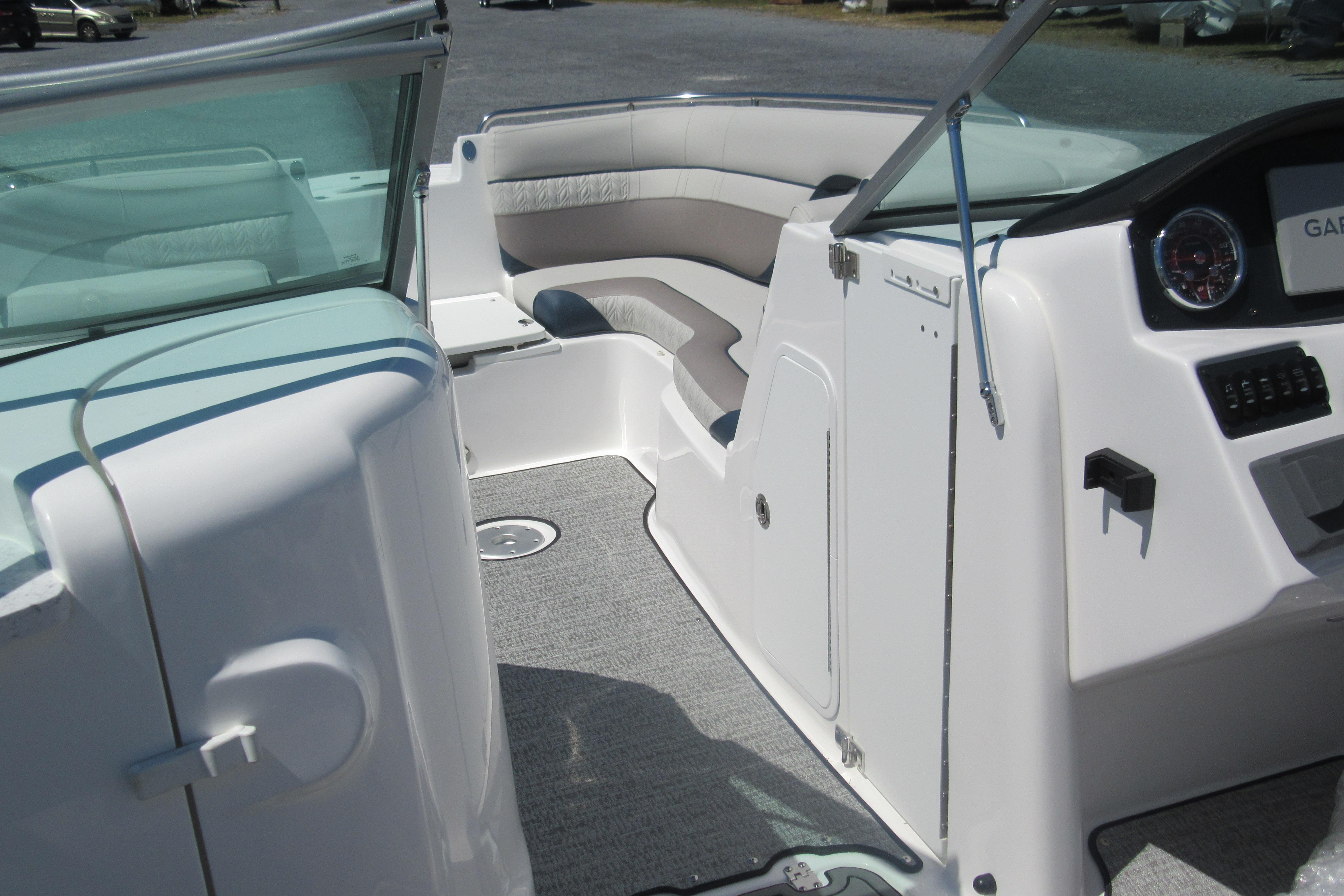 Interior view of 2027 Hurricane SunDeck 2486 OB boat, featuring seating and dashboard.