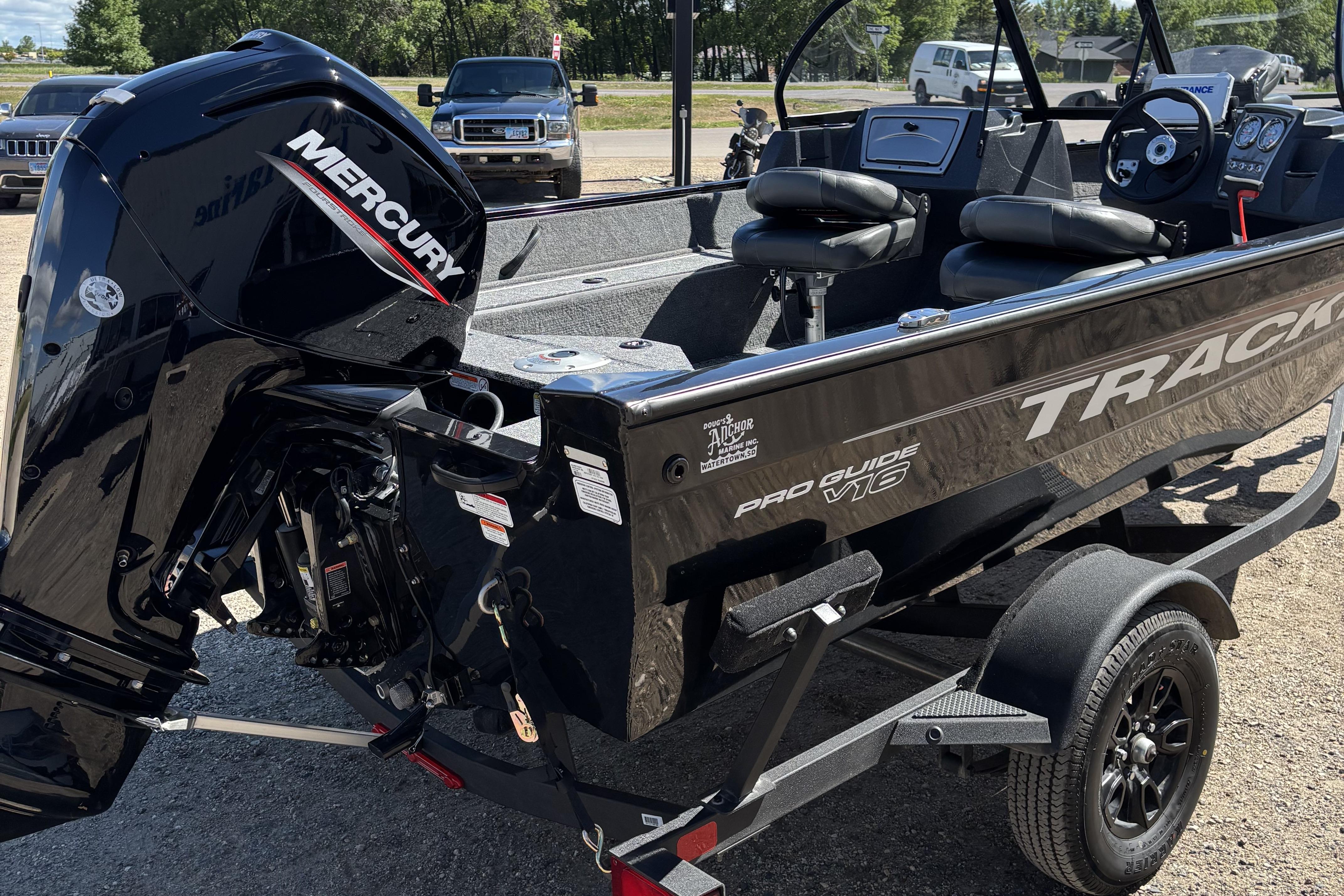 2026 Tracker Pro Guide V-16 WT boat with Mercury engine, parked on a trailer.