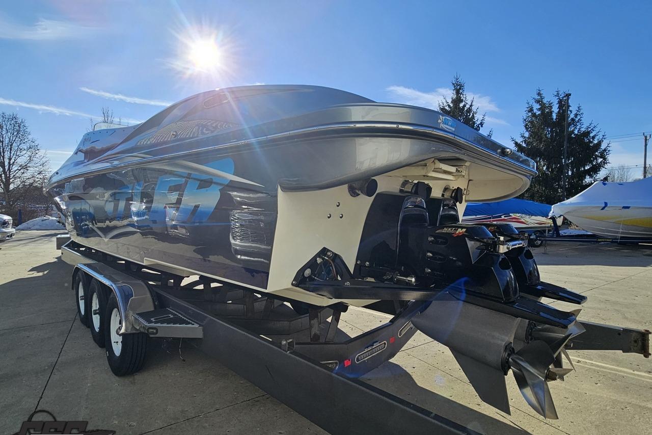 2007 Hustler 41 Razor boat on trailer under bright sun, showcasing sleek design and powerful engines.