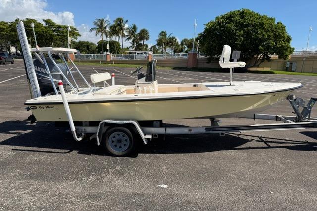 2002 Key West 1760 Stealth boat on trailer in sunny parking lot.