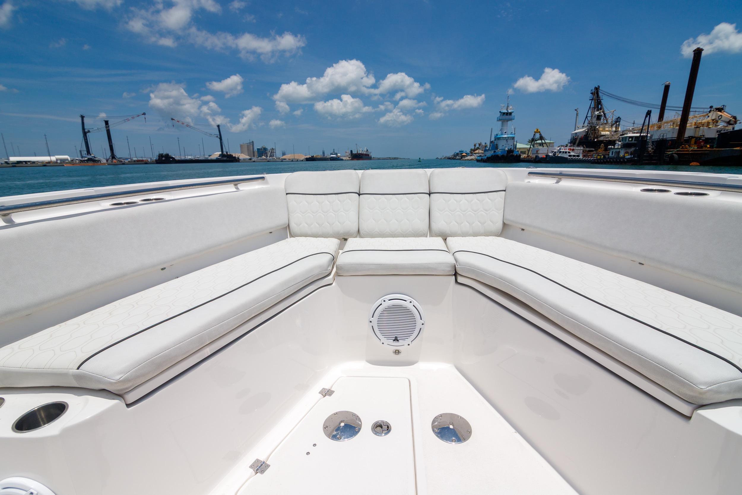 2021 Sea Fox 328 Commander boat interior with white seating, docked in a harbor.