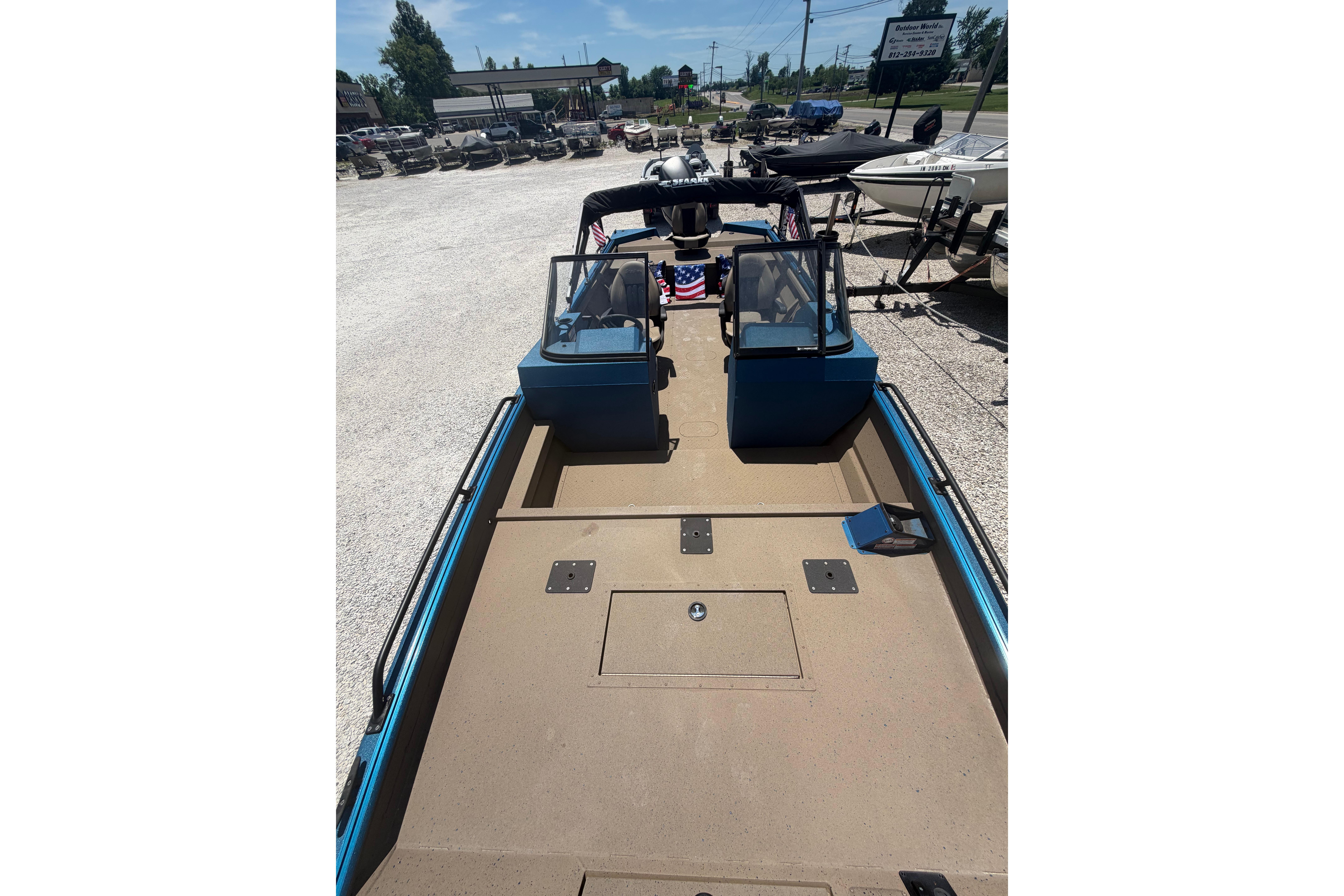 2025 SeaArk Protege 240 boat interior with dual consoles, parked outdoors.