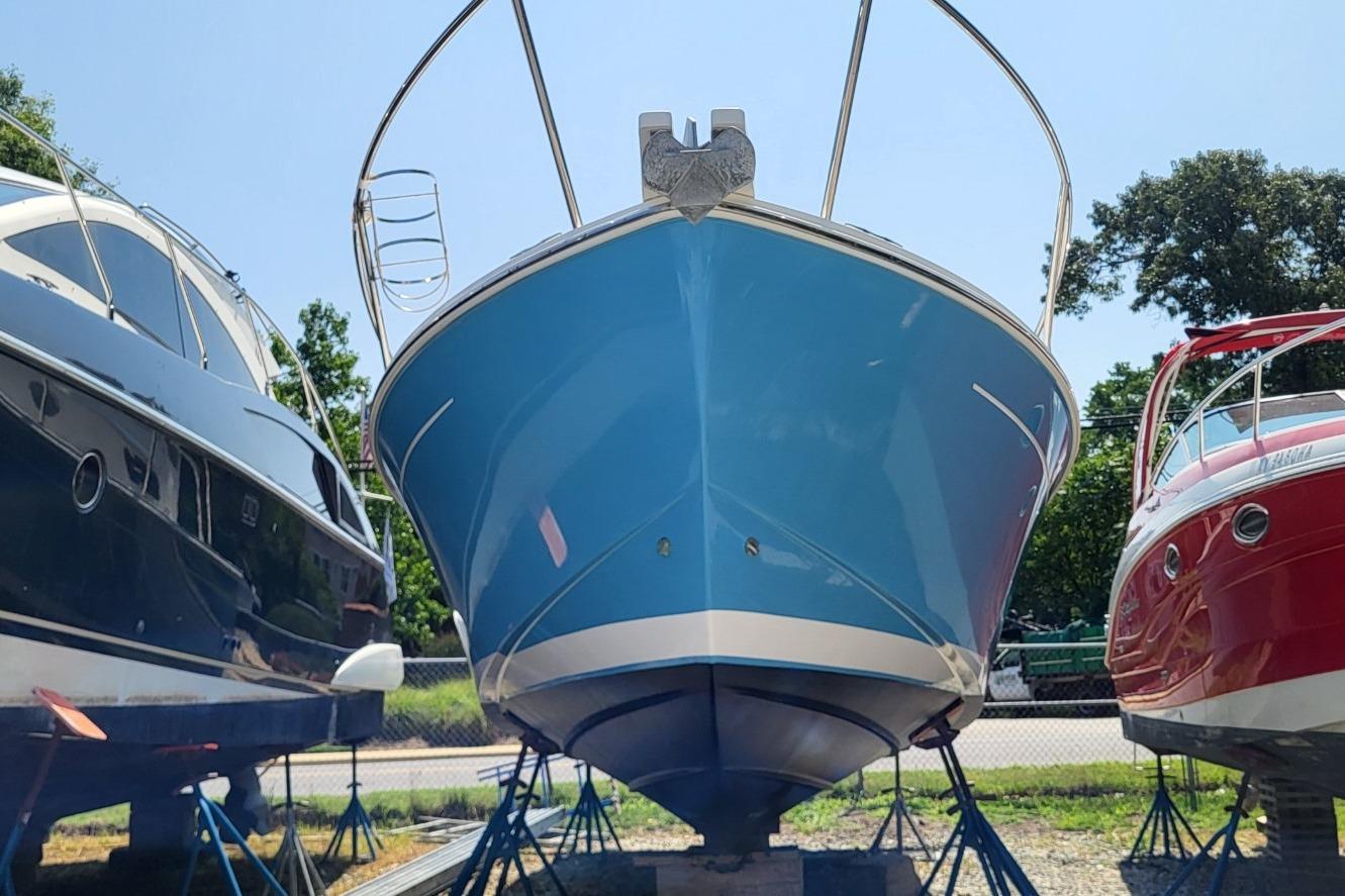 2006 Back Cove 29 boat in dry dock, flanked by two other boats.