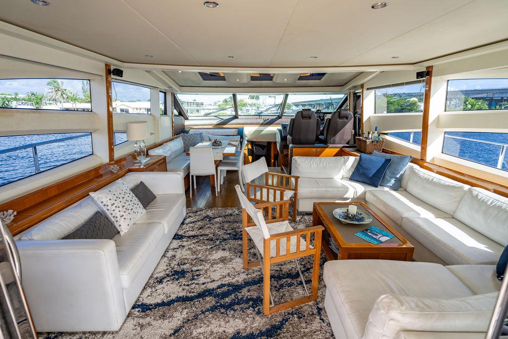 Luxurious interior of 2010 Princess V78 yacht with elegant seating and panoramic windows.