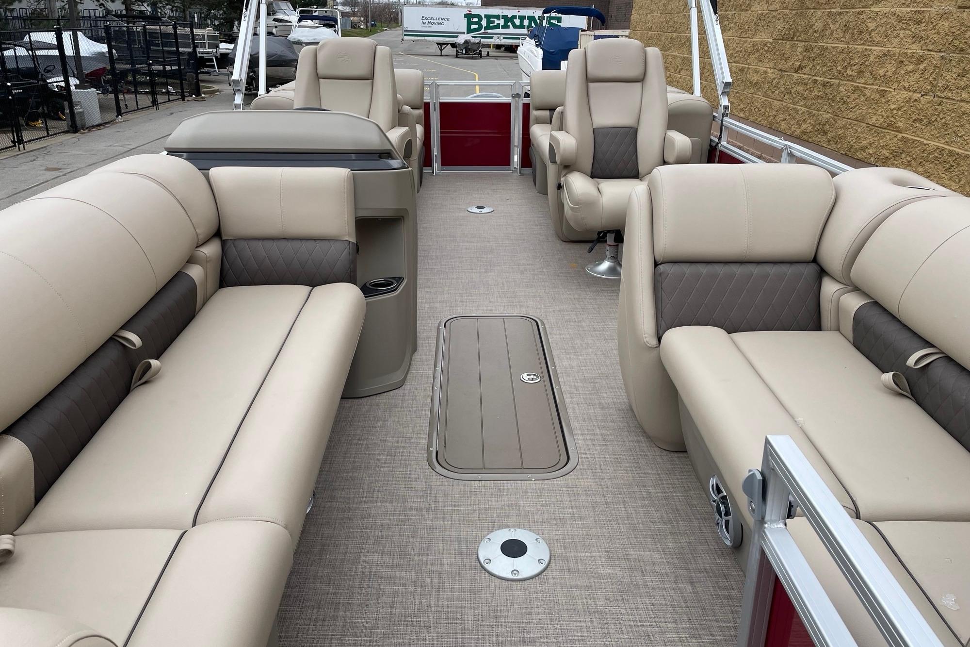 2025 Sun Tracker Party Barge 22 XP3 interior with beige seating and spacious layout.