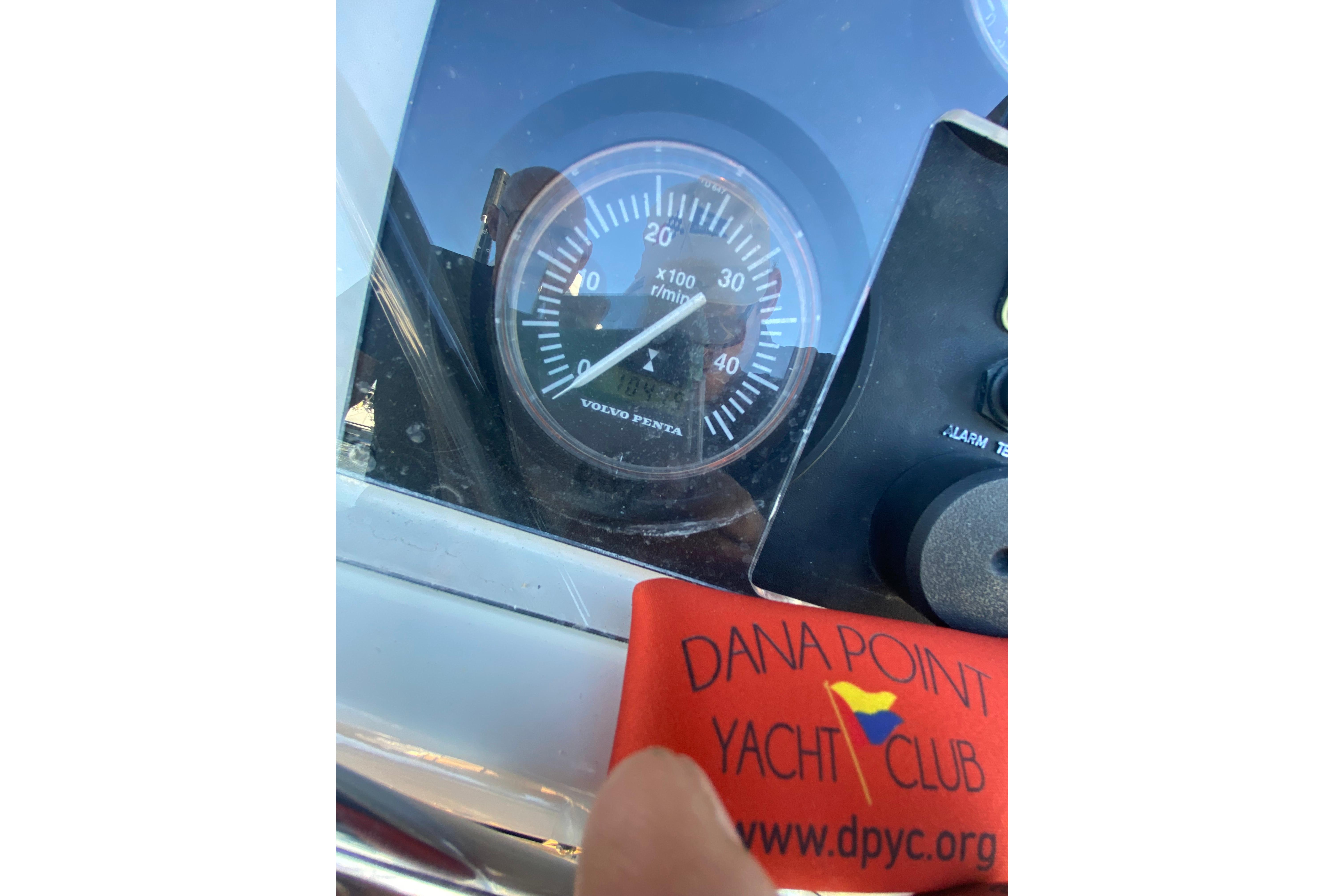 Close-up of a 1997 Hunter Legend 40.5 yacht tachometer with Dana Point Yacht Club tag.