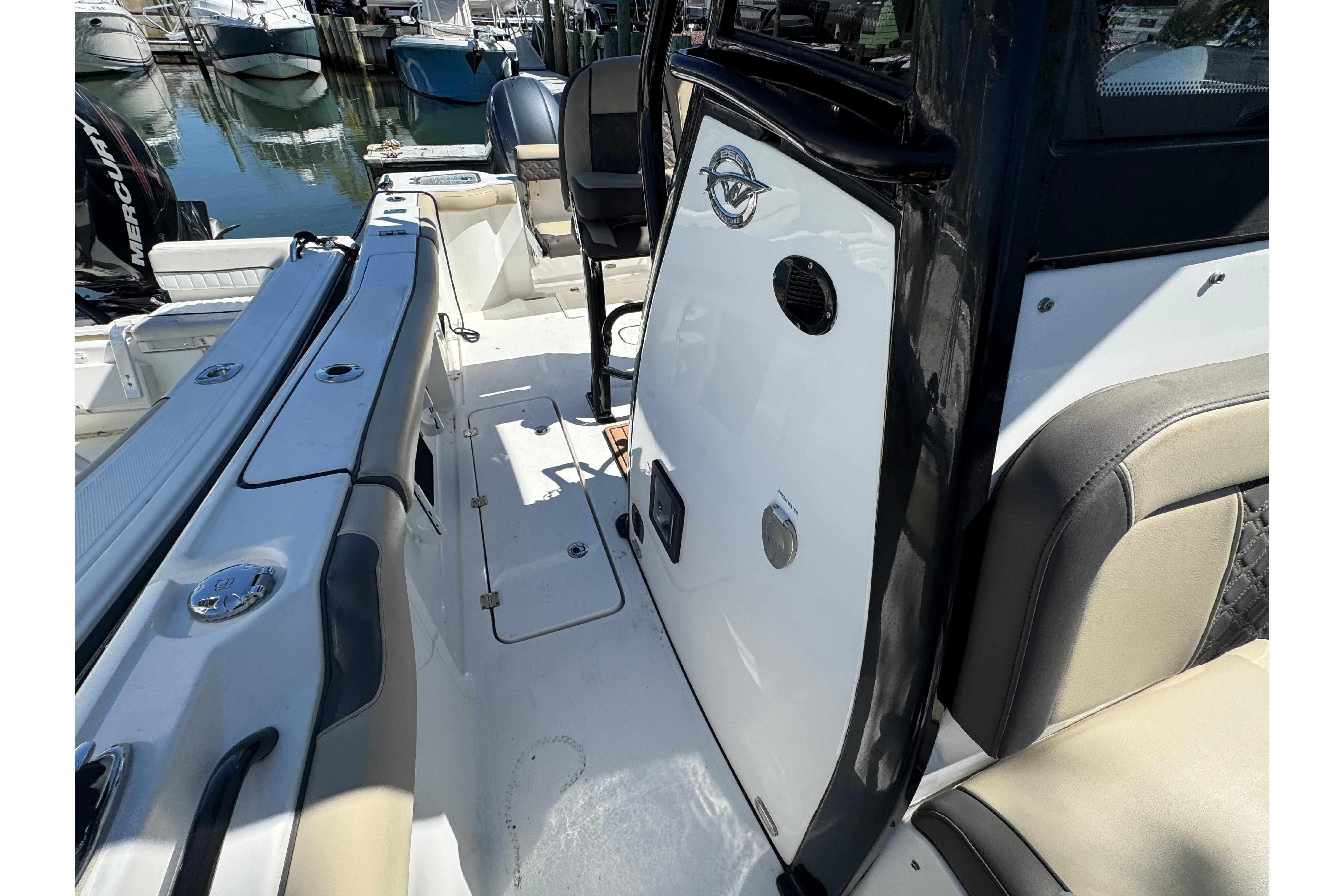 2022 Tidewater 256 CC Adventure boat interior with seating and deck details.