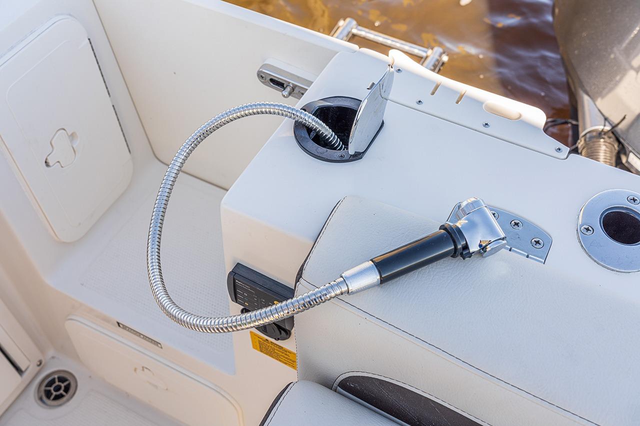 Sailfish 245 DC 2026 boat deck with flexible hose and fittings.