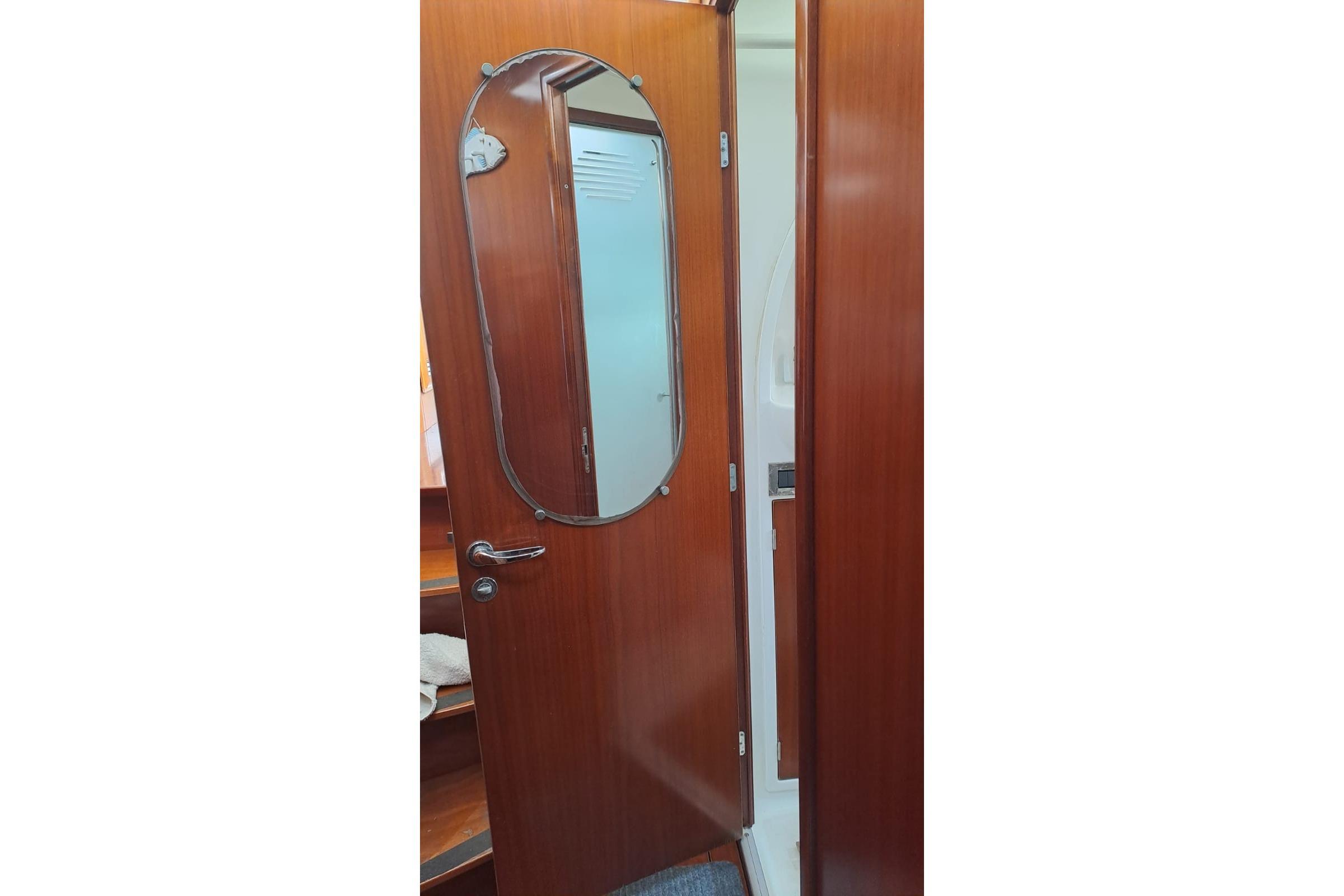 Interior view of 2004 Beneteau Swift Trawler 42 with wooden door and mirror.
