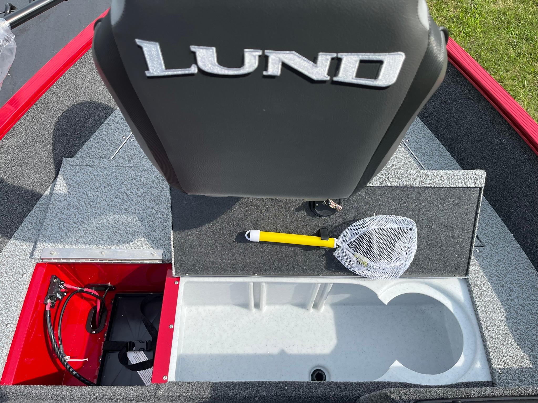 2026 Lund 1650 Angler SS boat interior with storage compartments and fishing net.