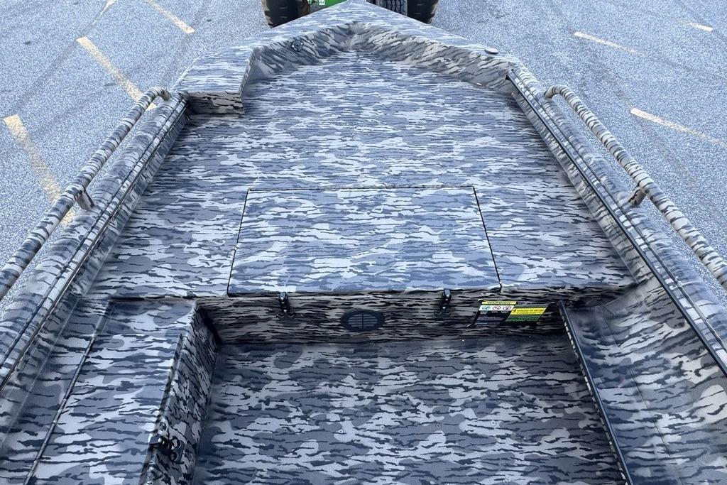 2026 Havoc 1756 boat interior with camouflage pattern, featuring spacious deck and storage compartments.