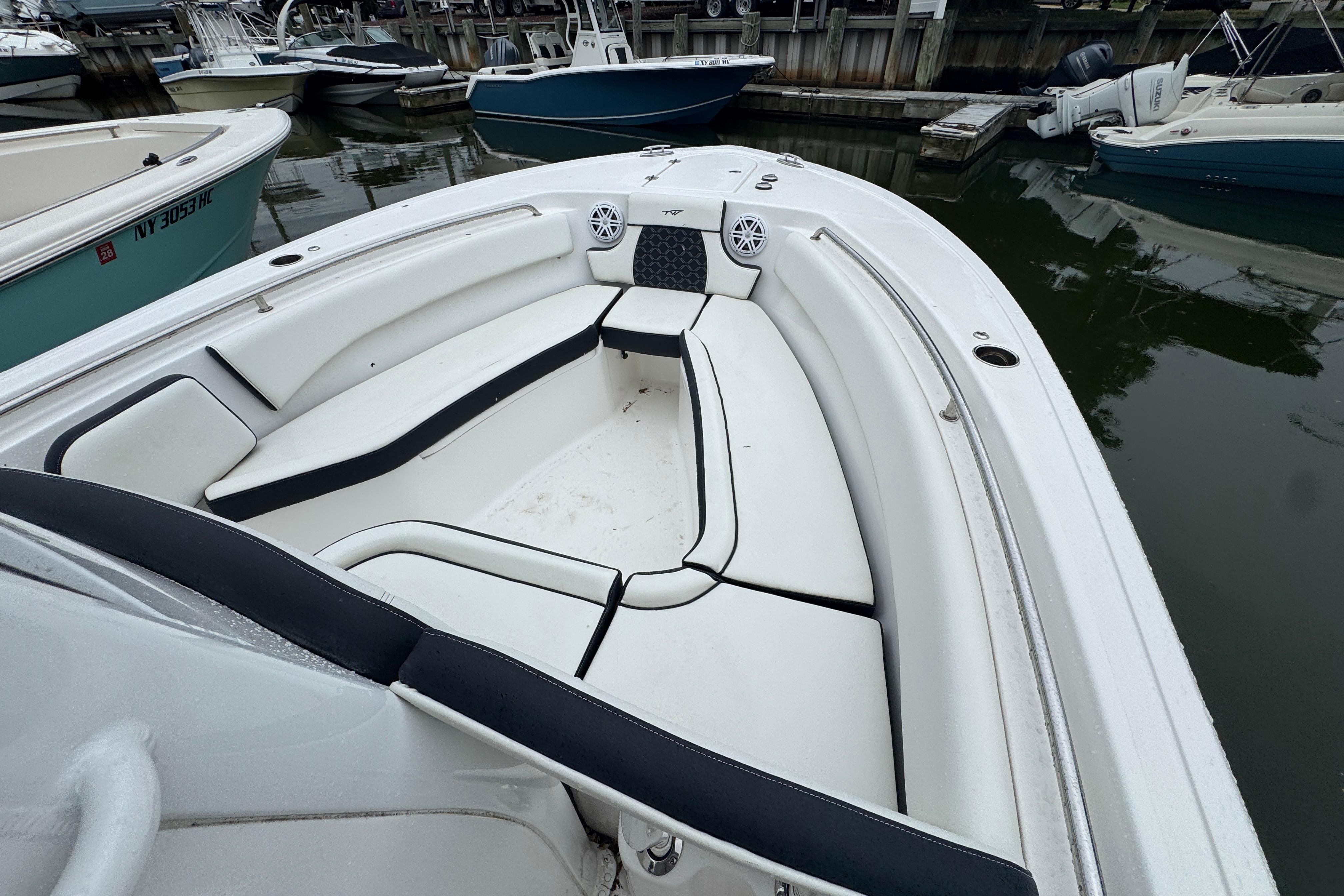 2022 Tidewater 232 SS boat with spacious white seating at a marina.