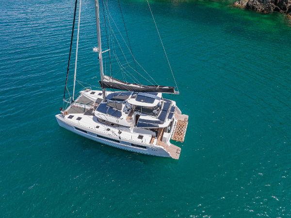 2025 Lagoon 51 ICONIC catamaran sailing on clear blue water.