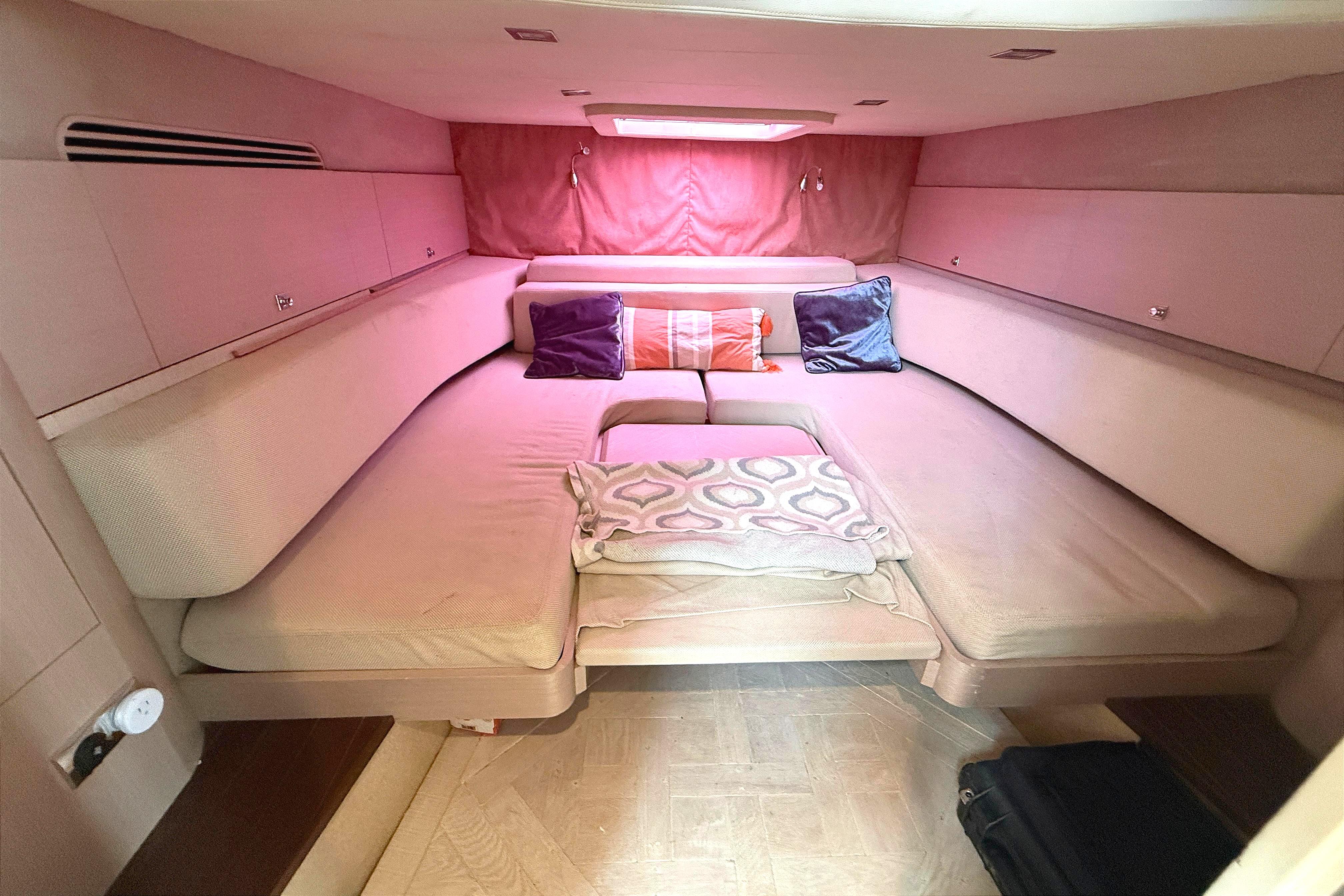 Luxurious cabin interior of 2013 Windy SR52 yacht with cozy bedding and cushions.
