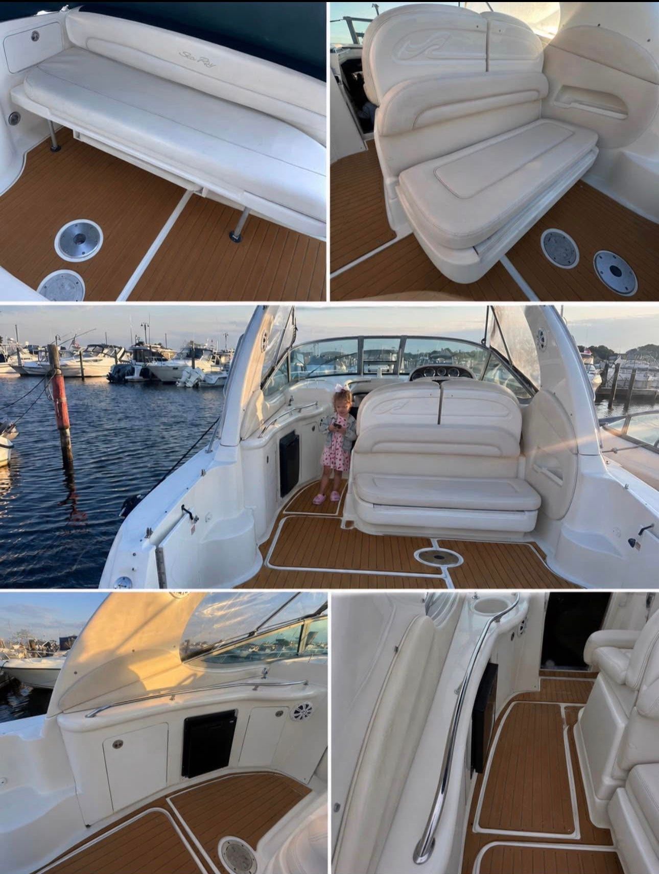 Interior of the 2002 Sea Ray 300 Sundancer with white seating and wood flooring.