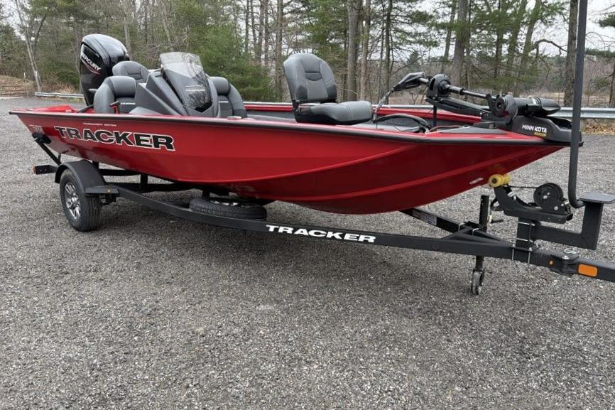 2026 Tracker Pro Team 175 boat on trailer, red color, parked outdoors.