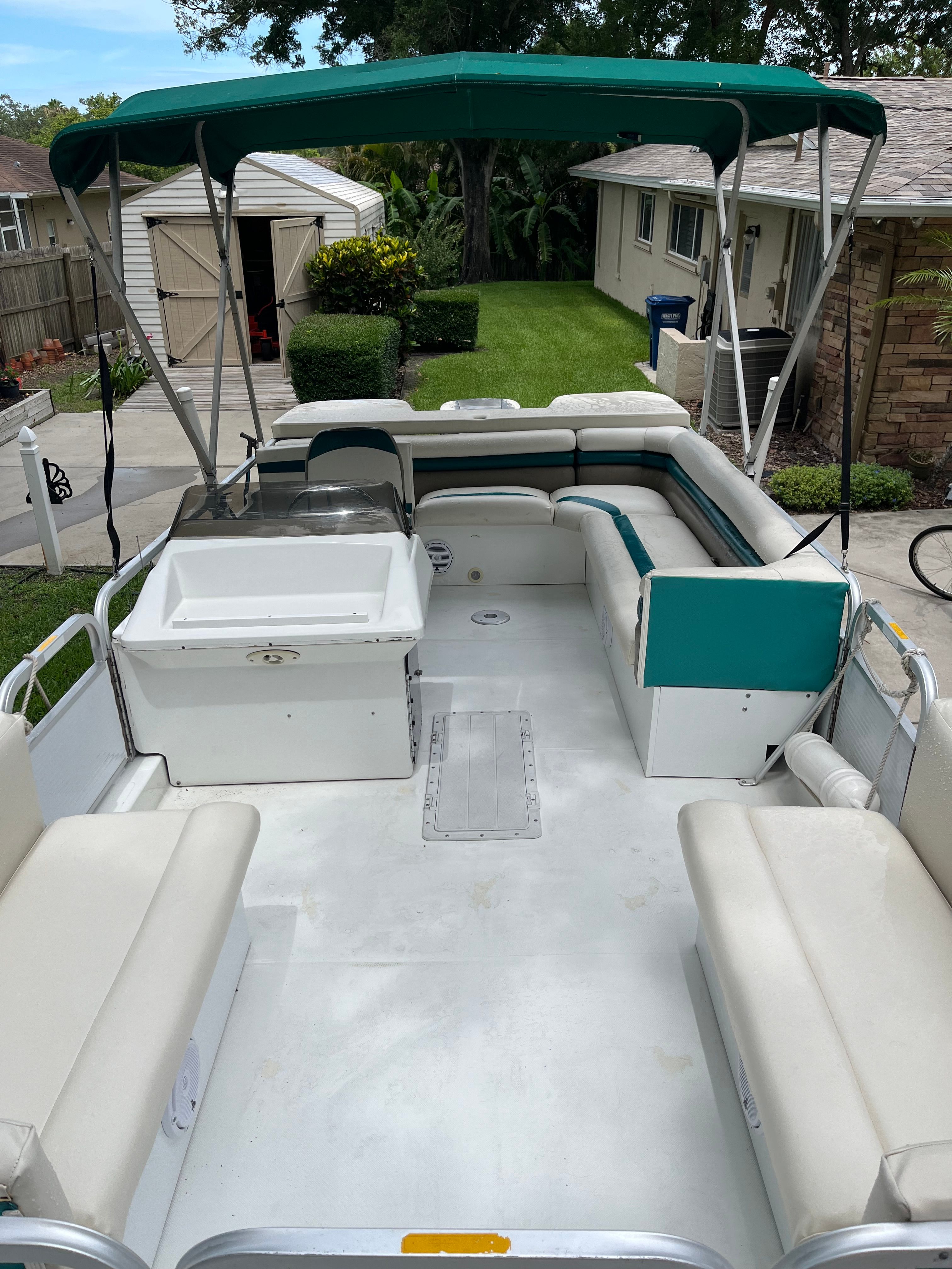 1993 Hurricane Fun Deck boat with seating area and canopy.