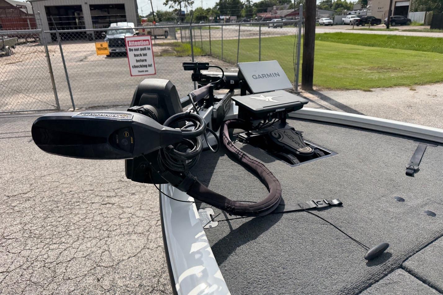 2024 Avid 21 XB Elite boat with Garmin equipment on deck, parked outdoors.