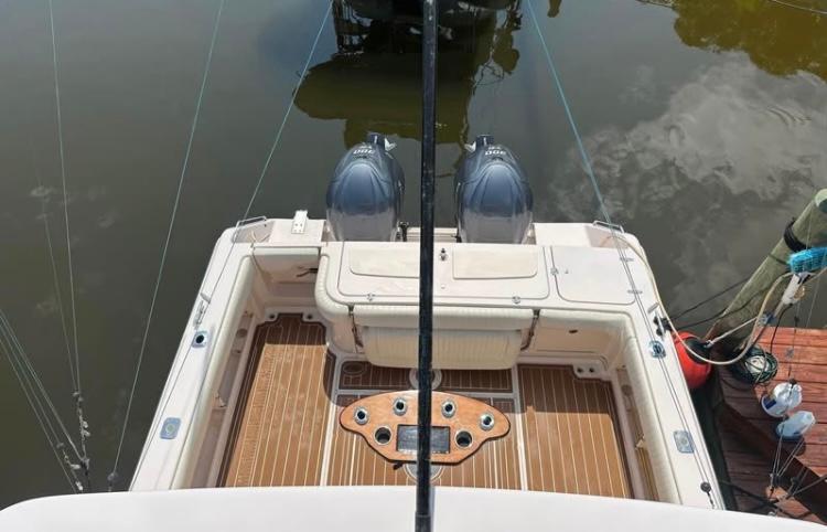 2007 Grady-White Express 330 boat with twin engines, docked on calm water.
