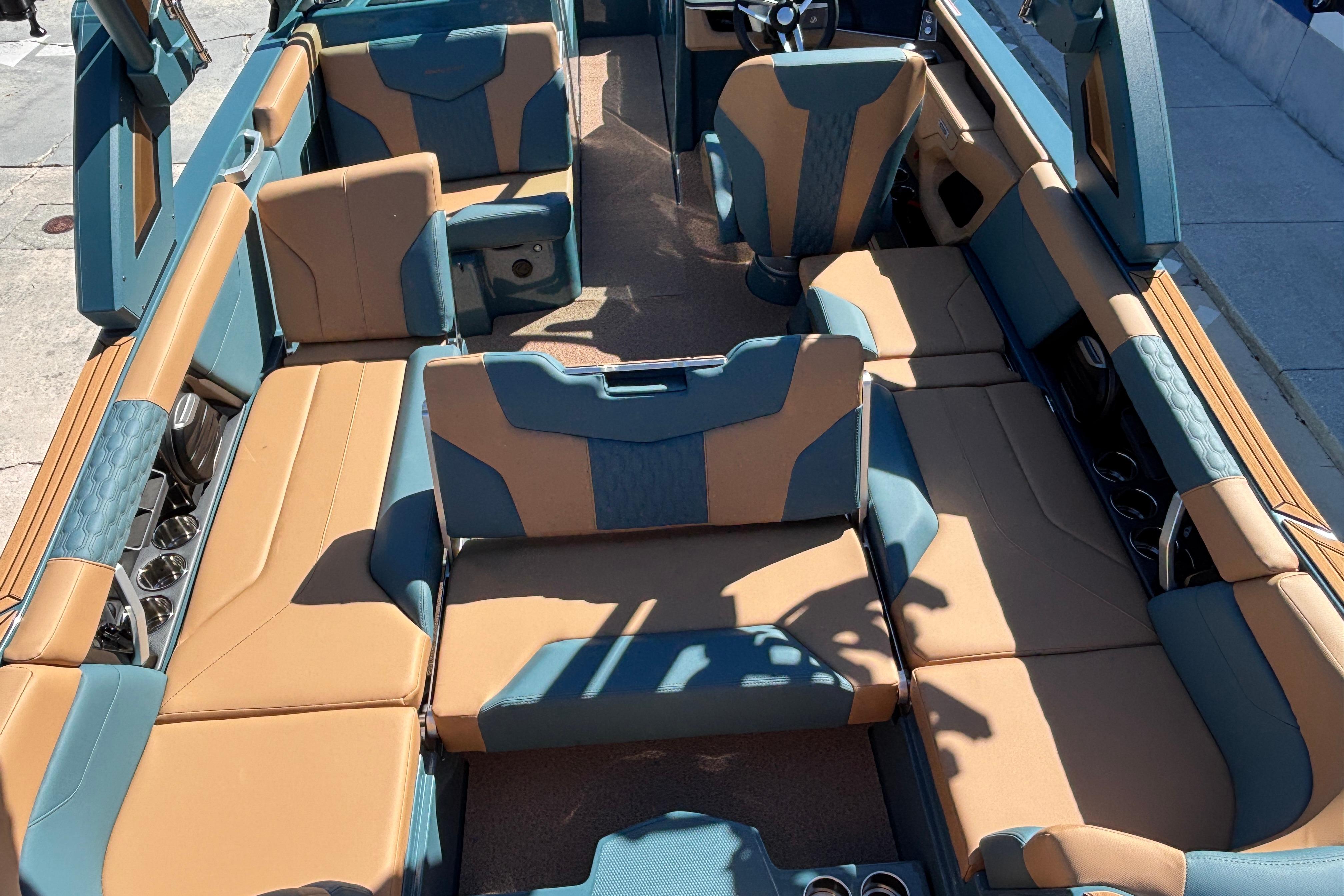 2026 MasterCraft XT24 boat interior with tan and blue seating, showcasing spacious and luxurious design.