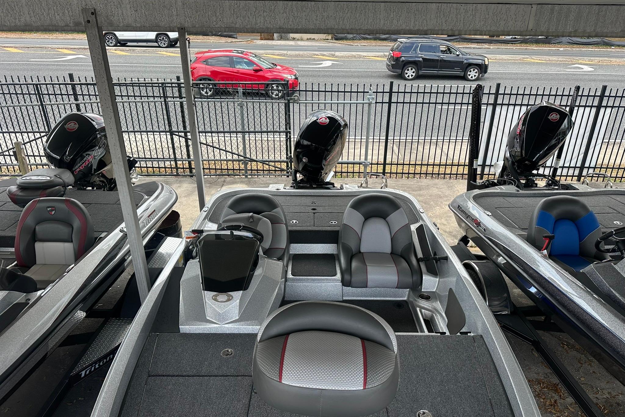 2025 Ranger Z185 boats displayed in a showroom, featuring sleek design and modern seating.