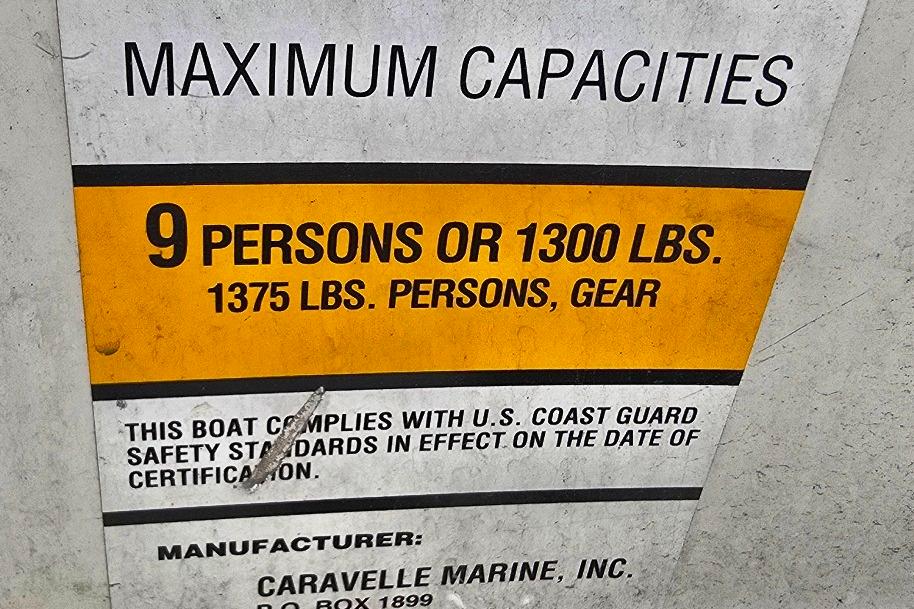 2003 Caravelle 187 Bow Rider capacity label: 9 persons or 1300 lbs, U.S. Coast Guard compliant.