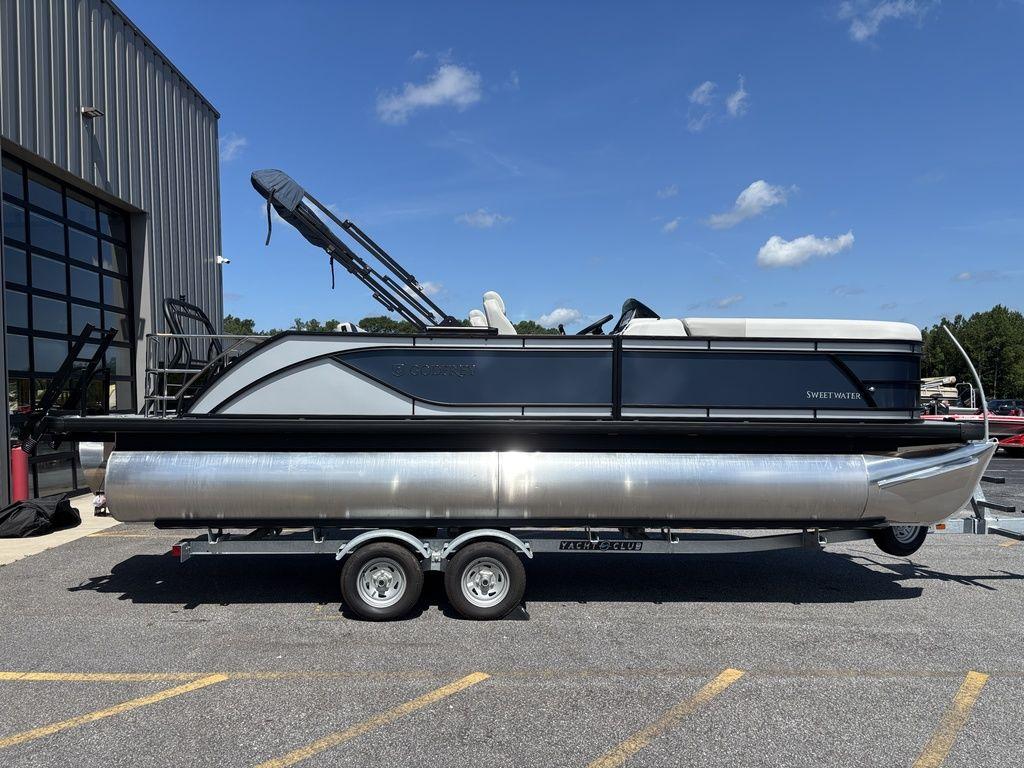 2026 Godfrey SWEETWATER 2286 SFL pontoon boat on trailer, parked outdoors.