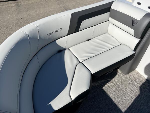 The 2023 Viaggio Lago 22U Tri Toon features a sleek, gray seating area with a modern design.