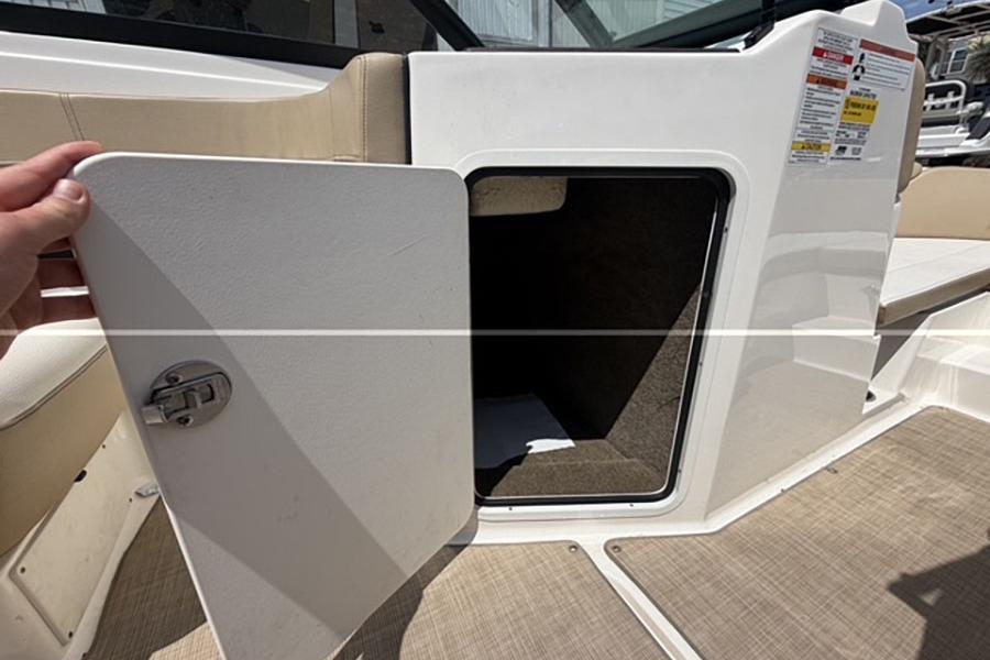 Open storage compartment on a 2018 Sea Ray SPX 190 boat interior.