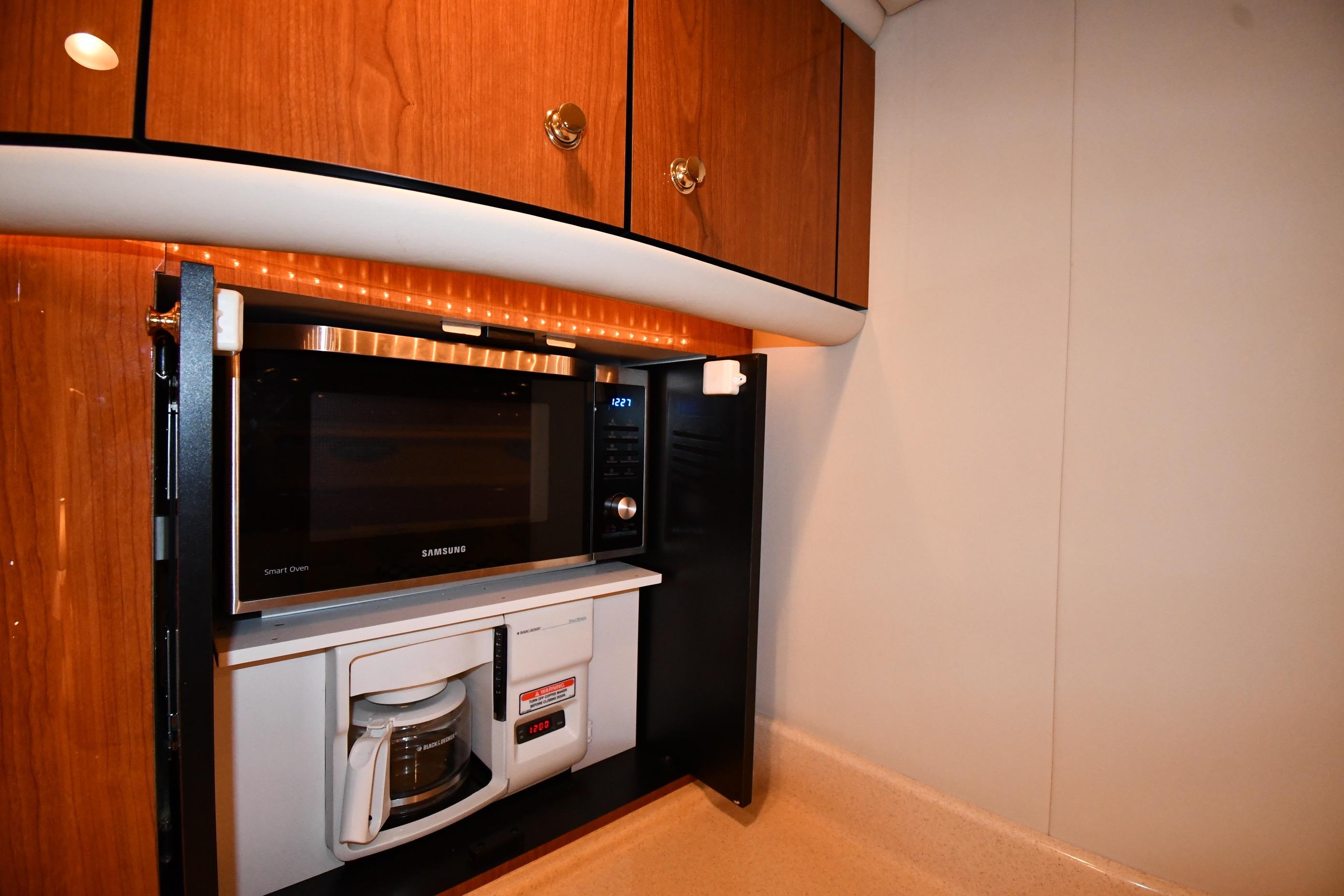 2001 Sea Ray 540 Sundancer kitchen with Samsung microwave and coffee maker.