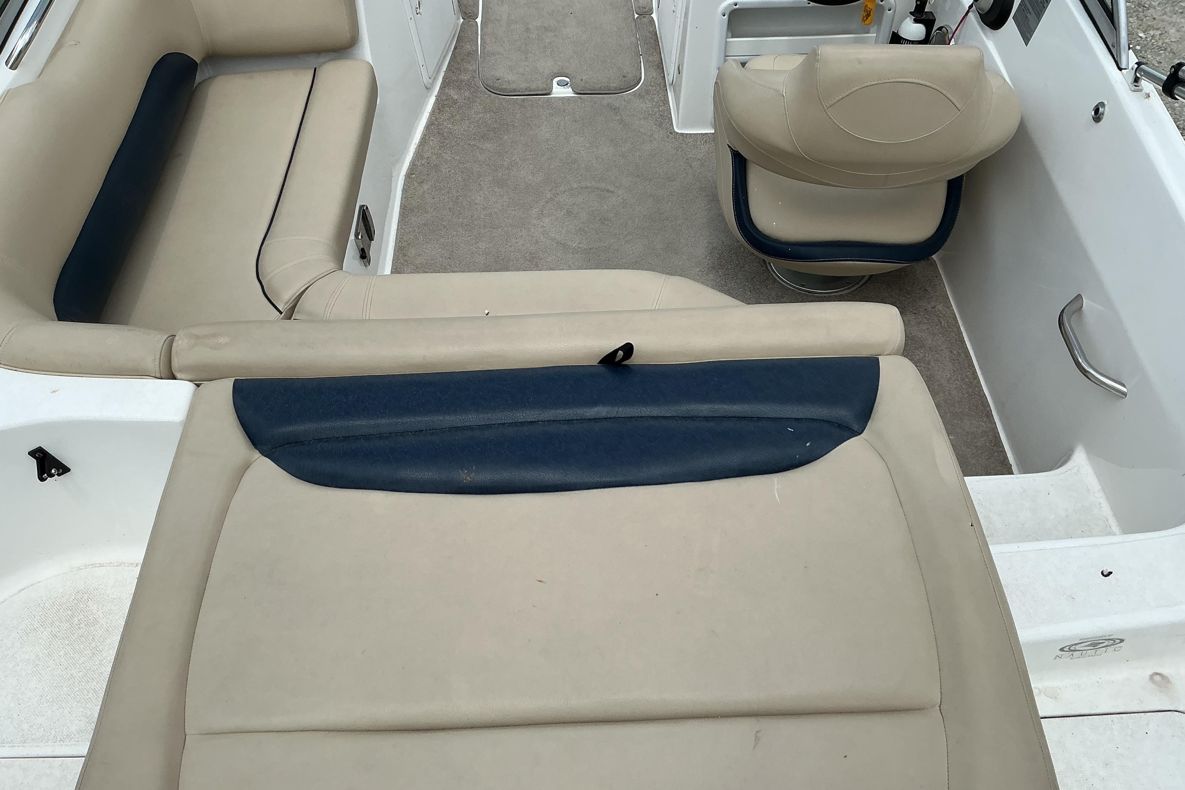Interior of a 2015 Hurricane SunDeck 187 IO boat with beige seating.
