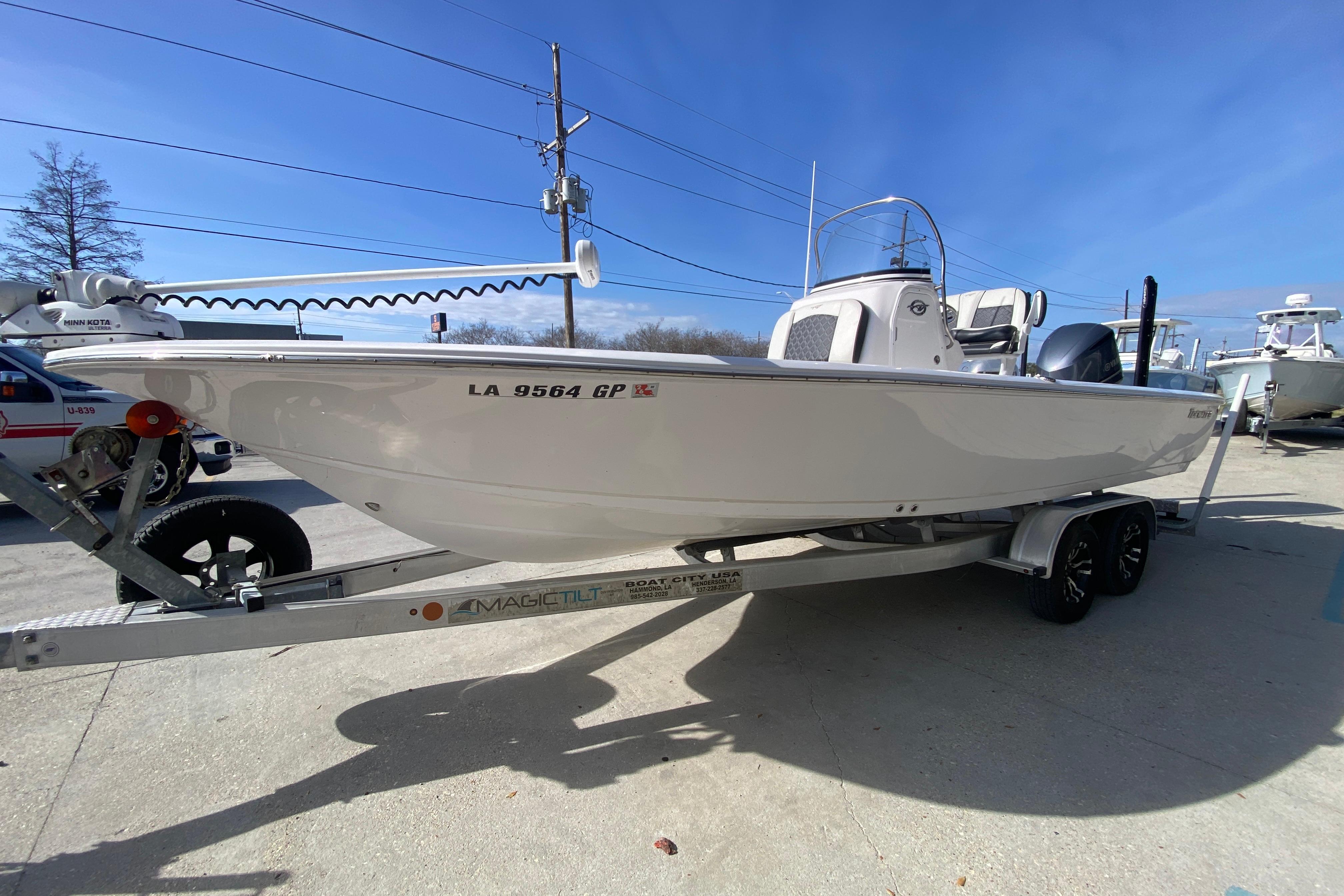 2023 Tidewater 2410 Bay Max boat on trailer, displayed outdoors under clear blue sky.