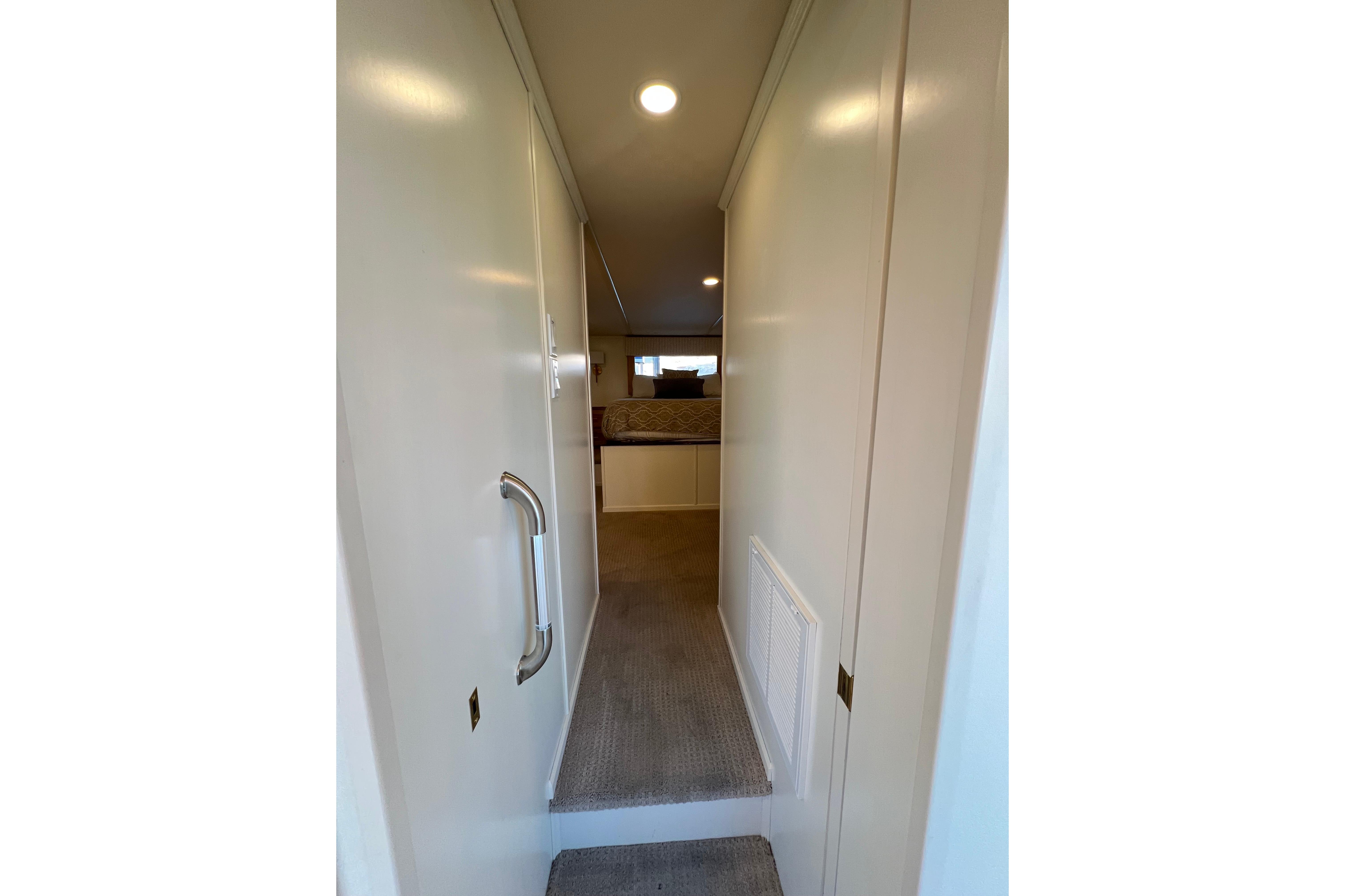 Narrow hallway in 2025 Sumerset Excellence Multiple Shares houseboat, leading to a cozy bedroom.