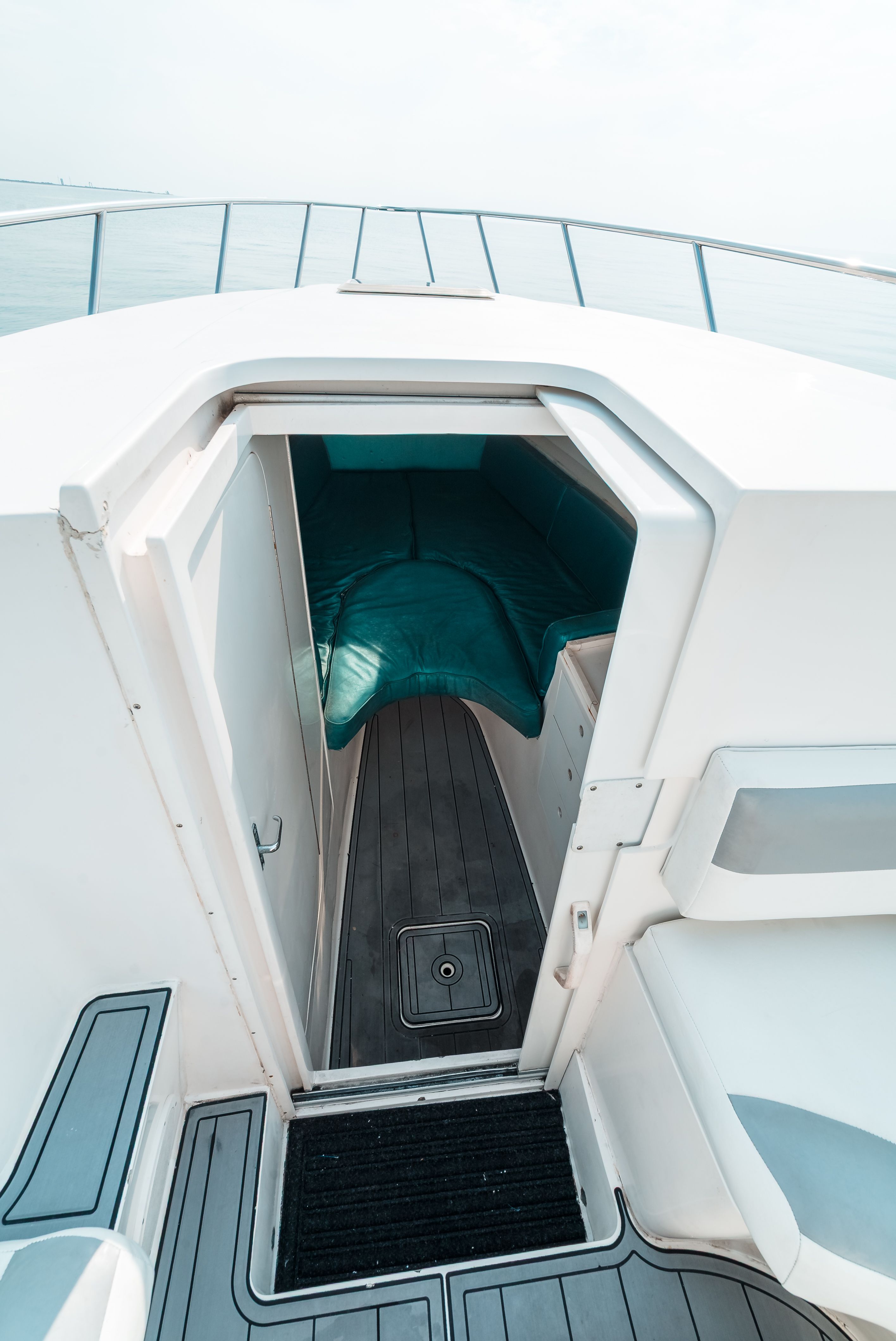 View into the cabin of a 2006 Tempest Offshore 40 with gray flooring.