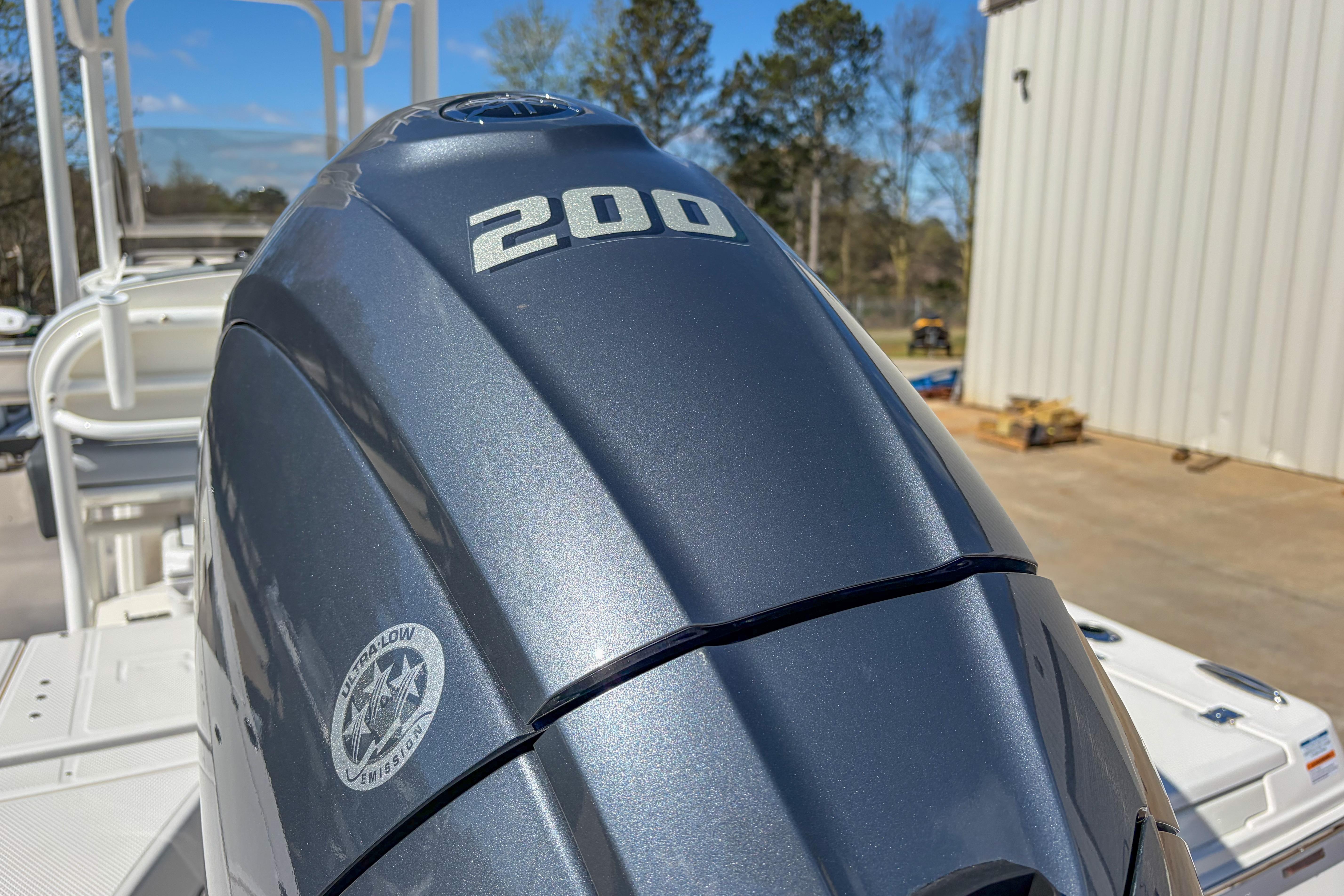 2025 Robalo 226 Cayman boat with a 200 horsepower engine, outdoor setting.
