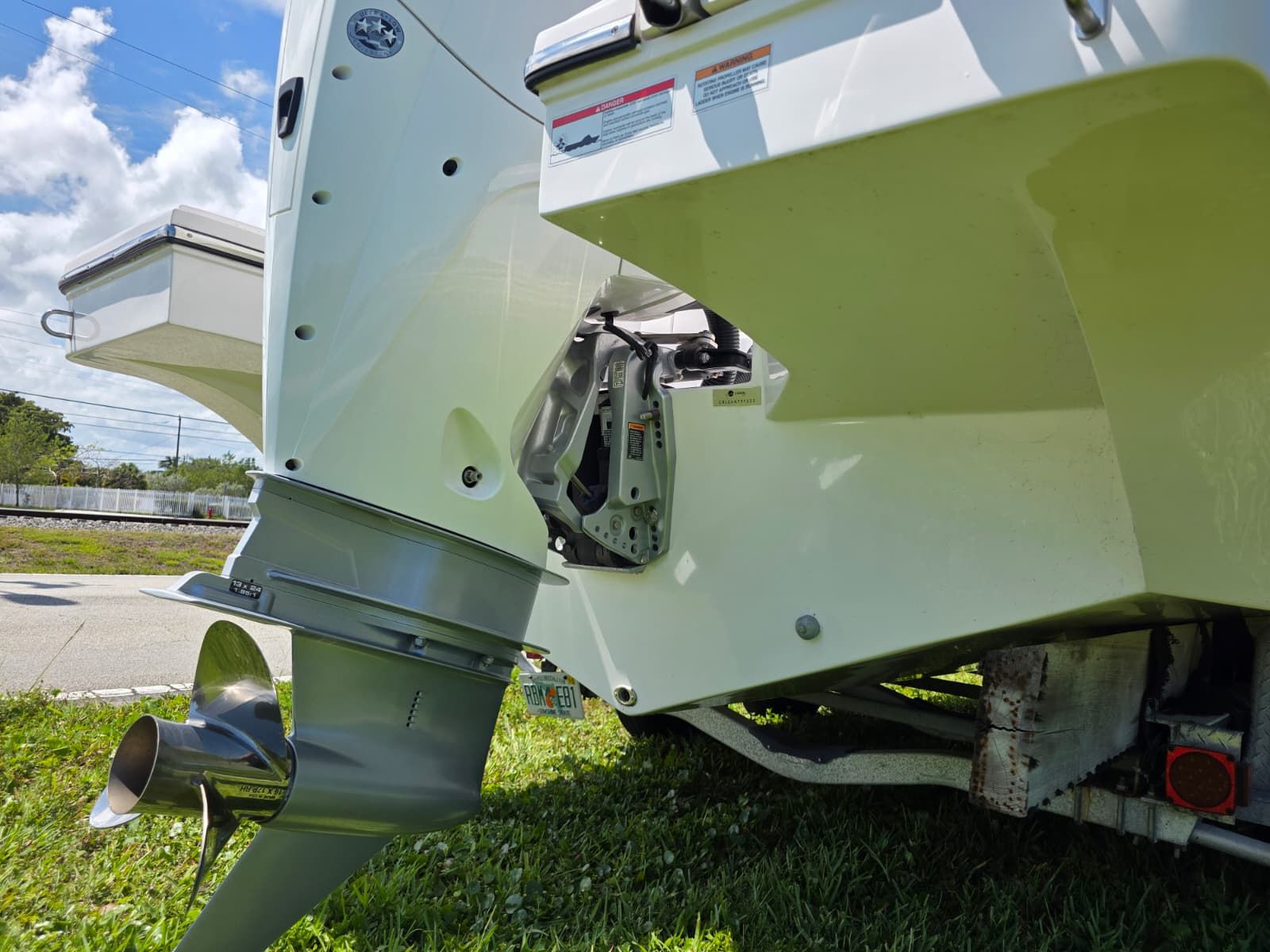 The image shows the stern of a boat with an outboard motor and propeller.