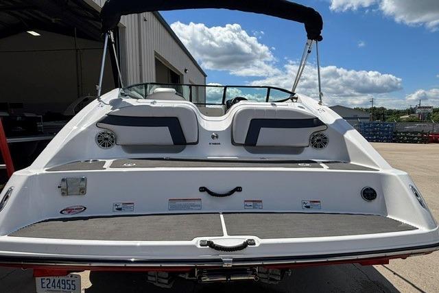 2014 Yamaha Boats 212X, rear view, docked under a partly cloudy sky.