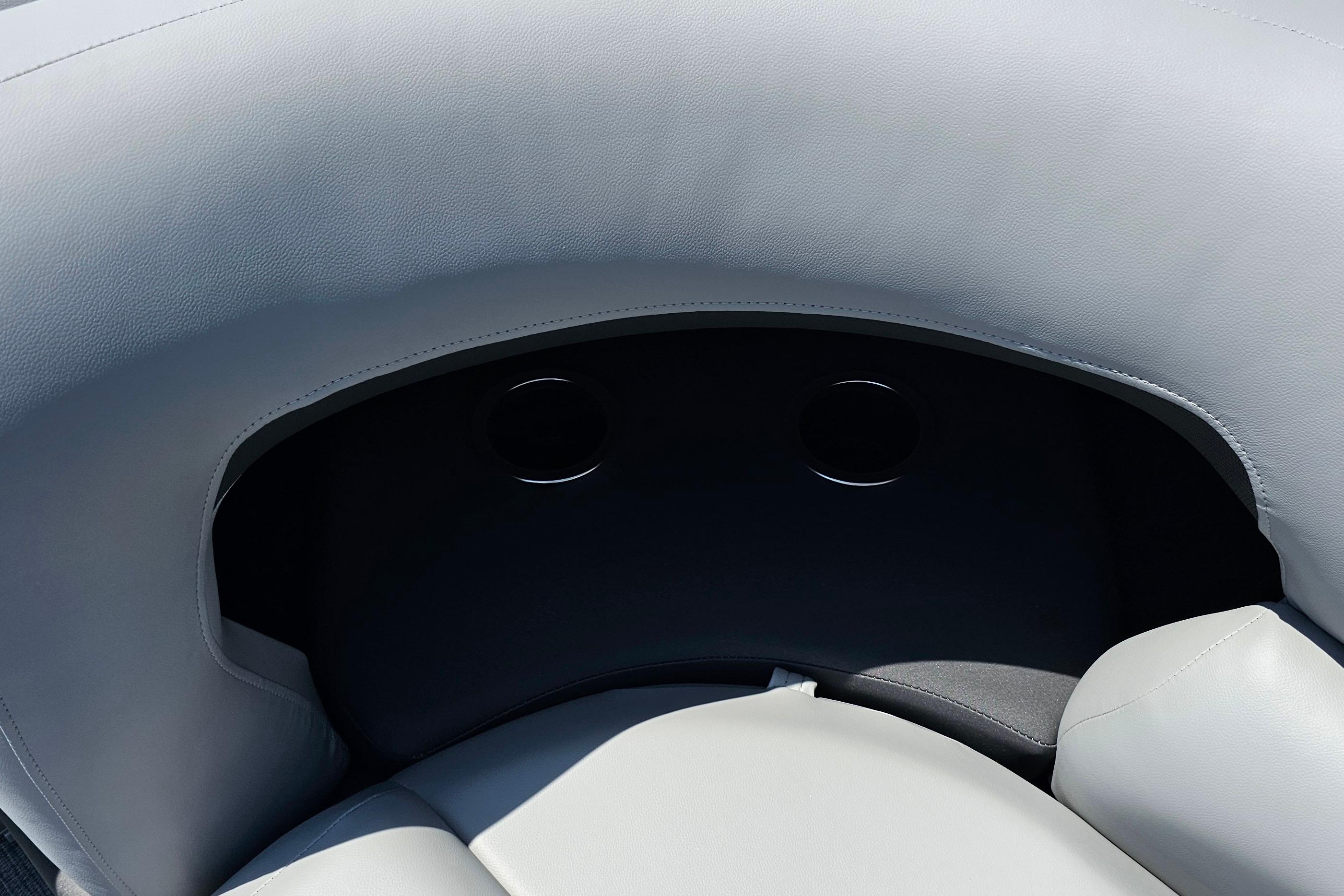 2026 Sun Tracker SportFish 20 DLX boat seating with cup holders, gray upholstery.