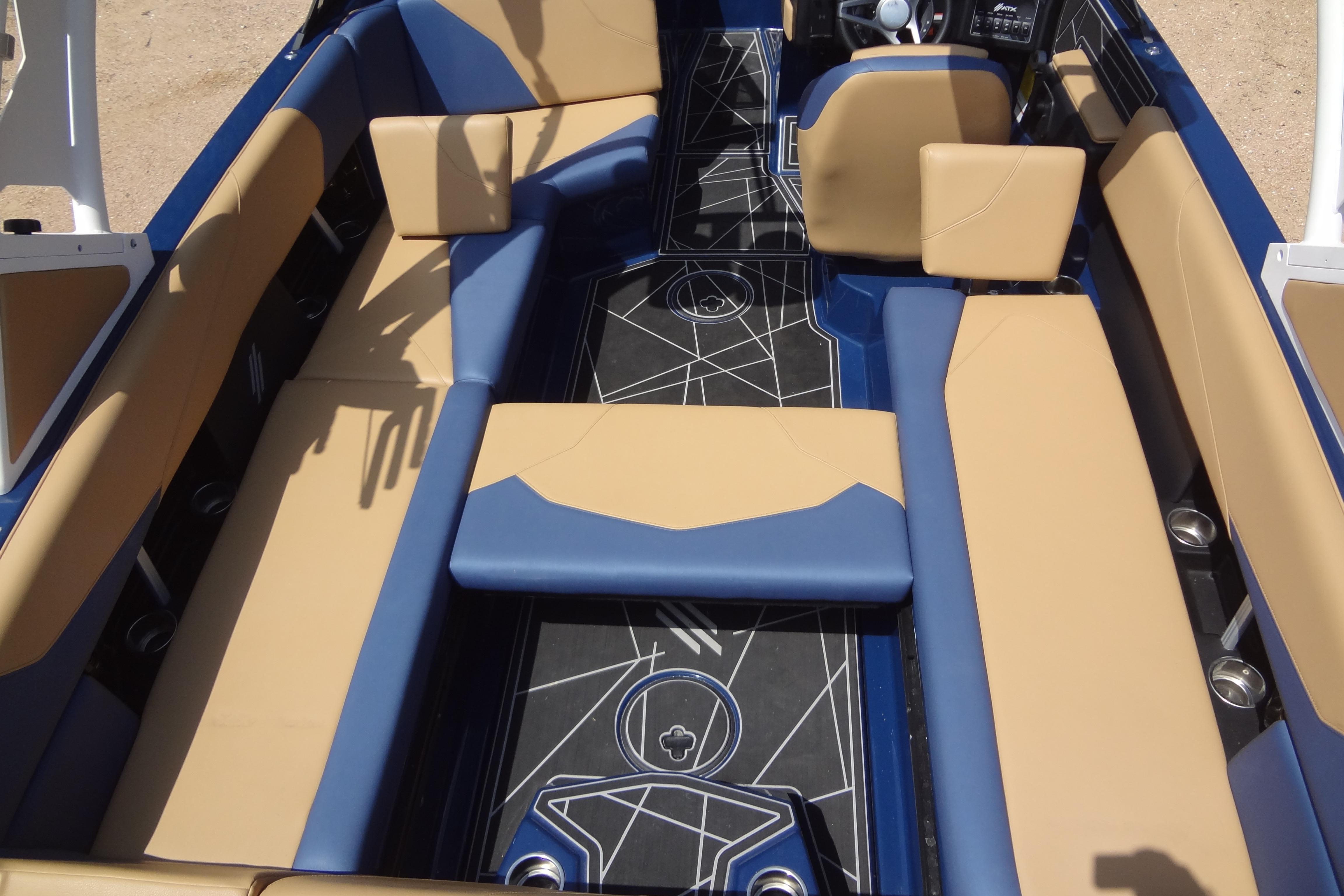 2022 ATX Surf Boats 24 Type-S interior with tan and blue seating, geometric floor design.
