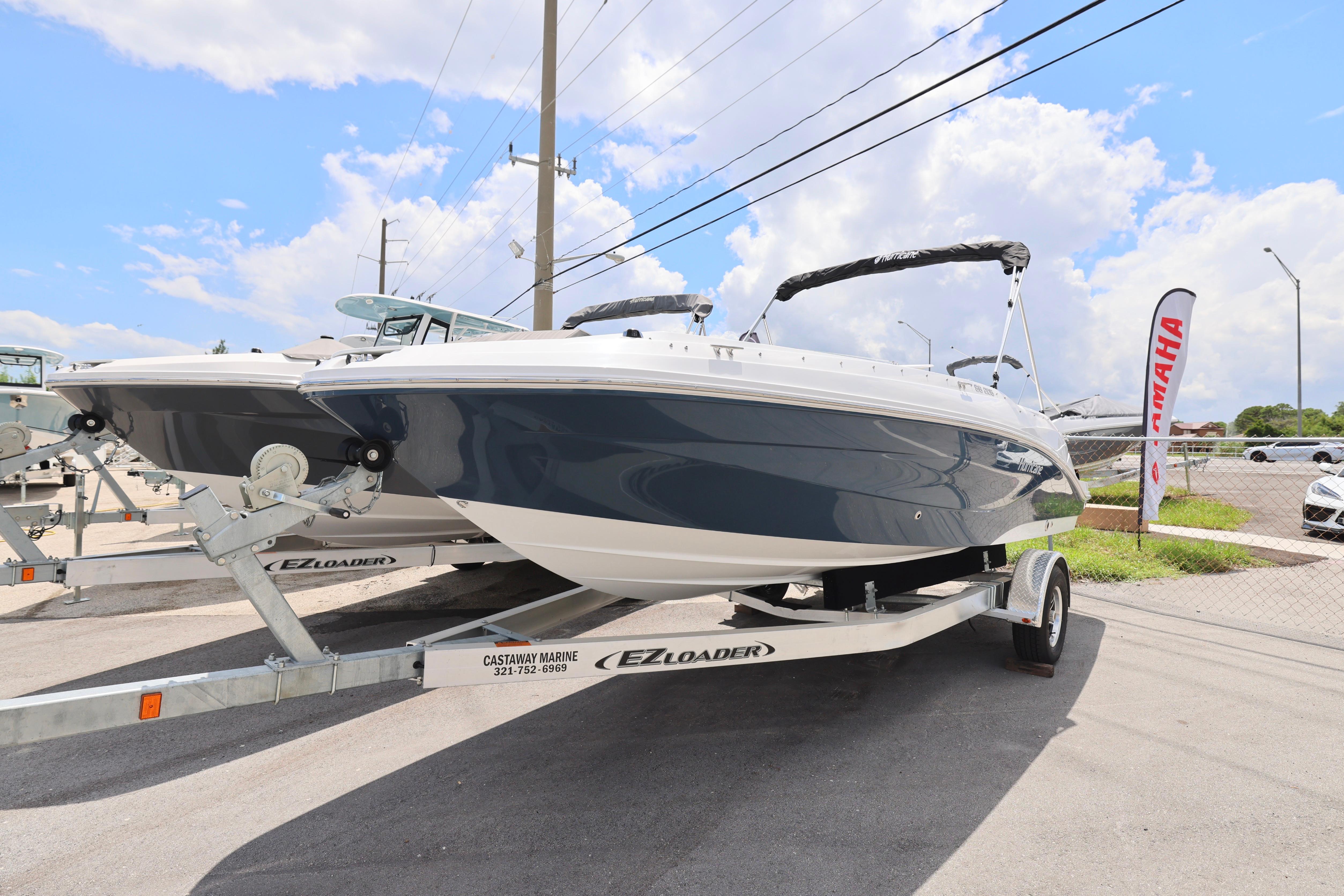 2026 Hurricane SunDeck Sport 205 OB boat on trailer under clear sky.