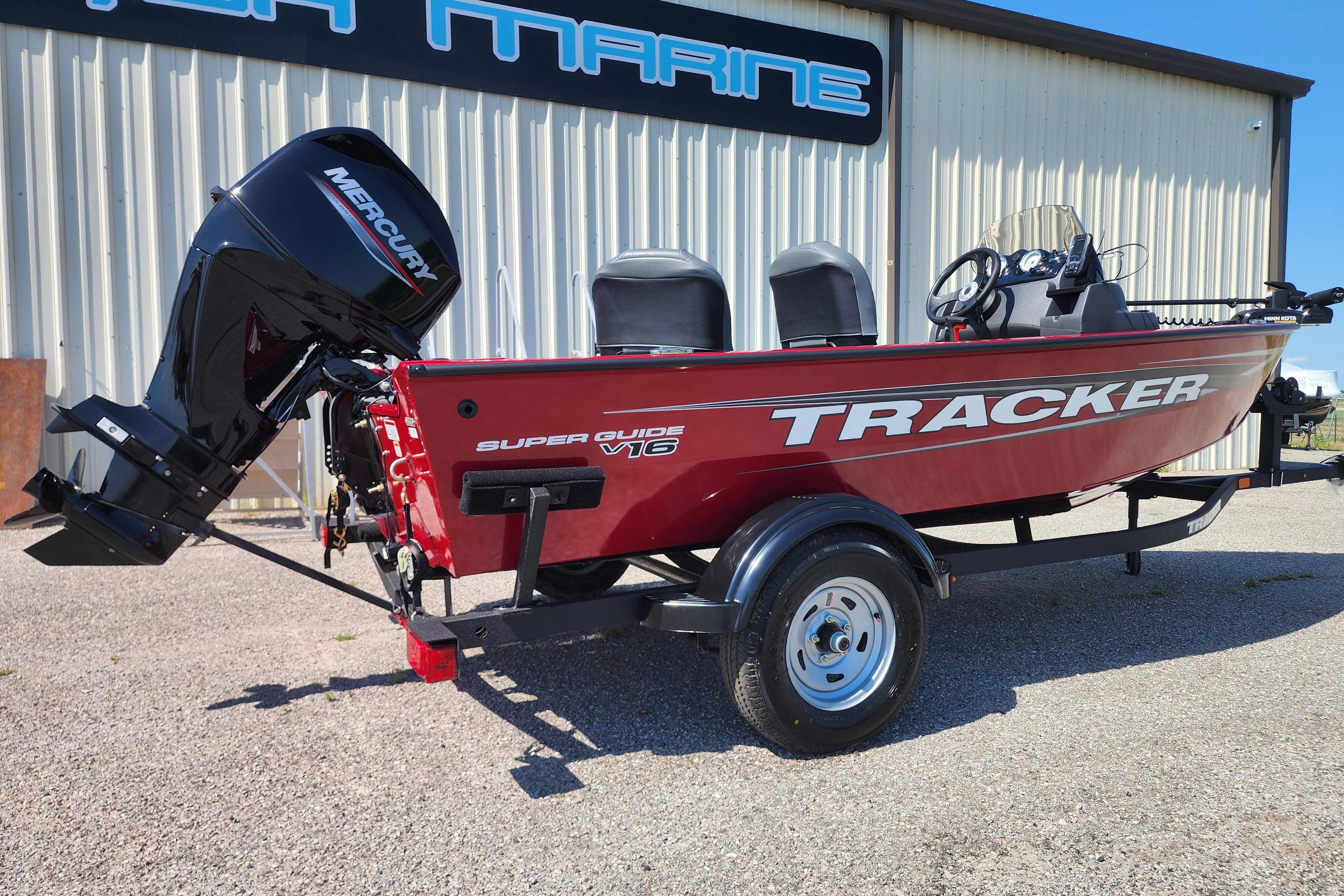 2026 Tracker Super Guide V-16 SC boat with Mercury engine, parked outdoors.